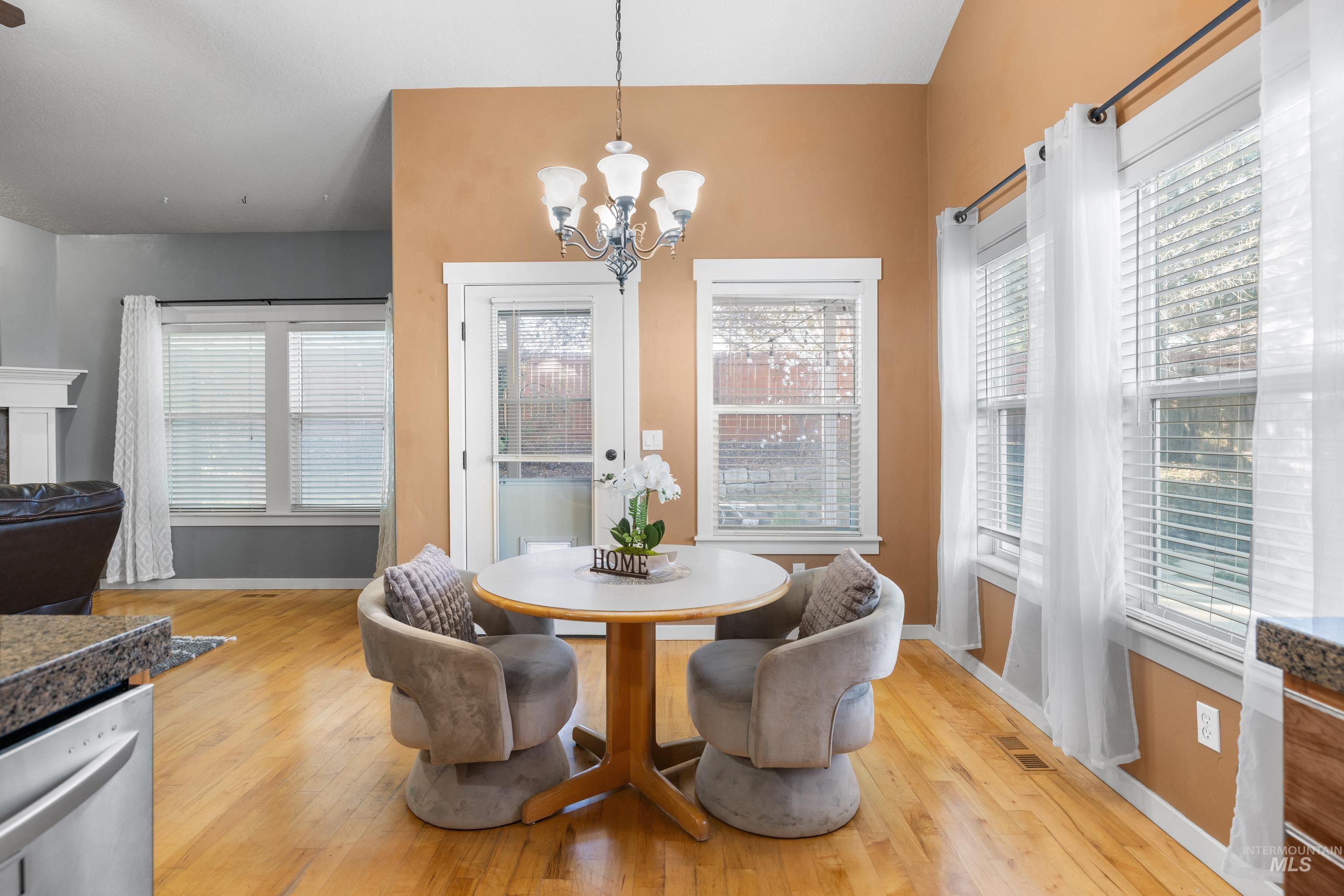 Dining area with a chandelier and light wood finished floors