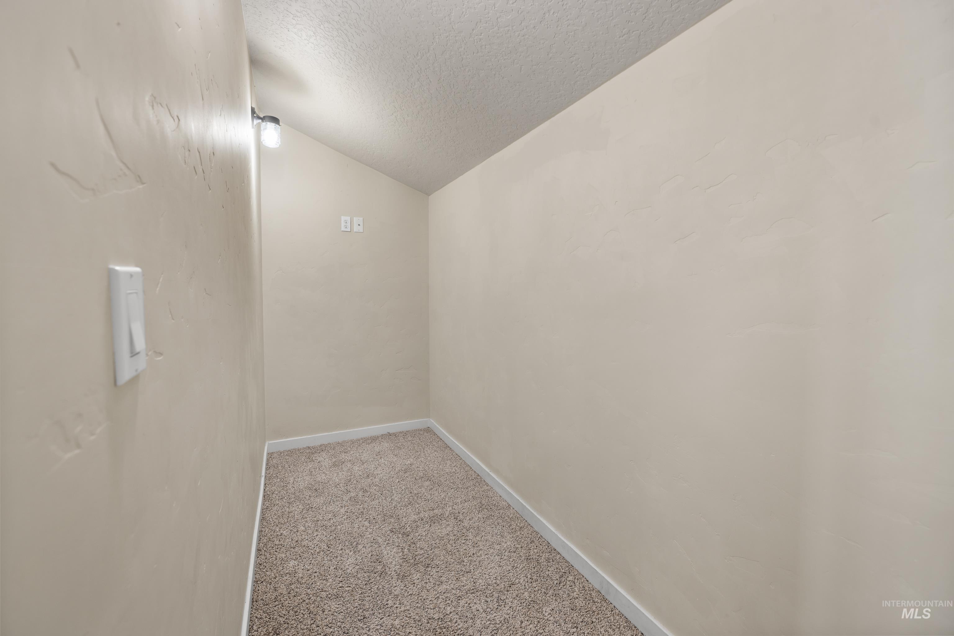 Unfurnished room with light colored carpet and baseboards