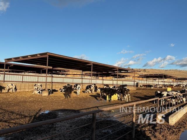 View of yard featuring a view of rural / pastoral area, an outdoor structure, and an exterior structure