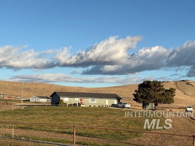 Rear view of house featuring a view of rural / pastoral area