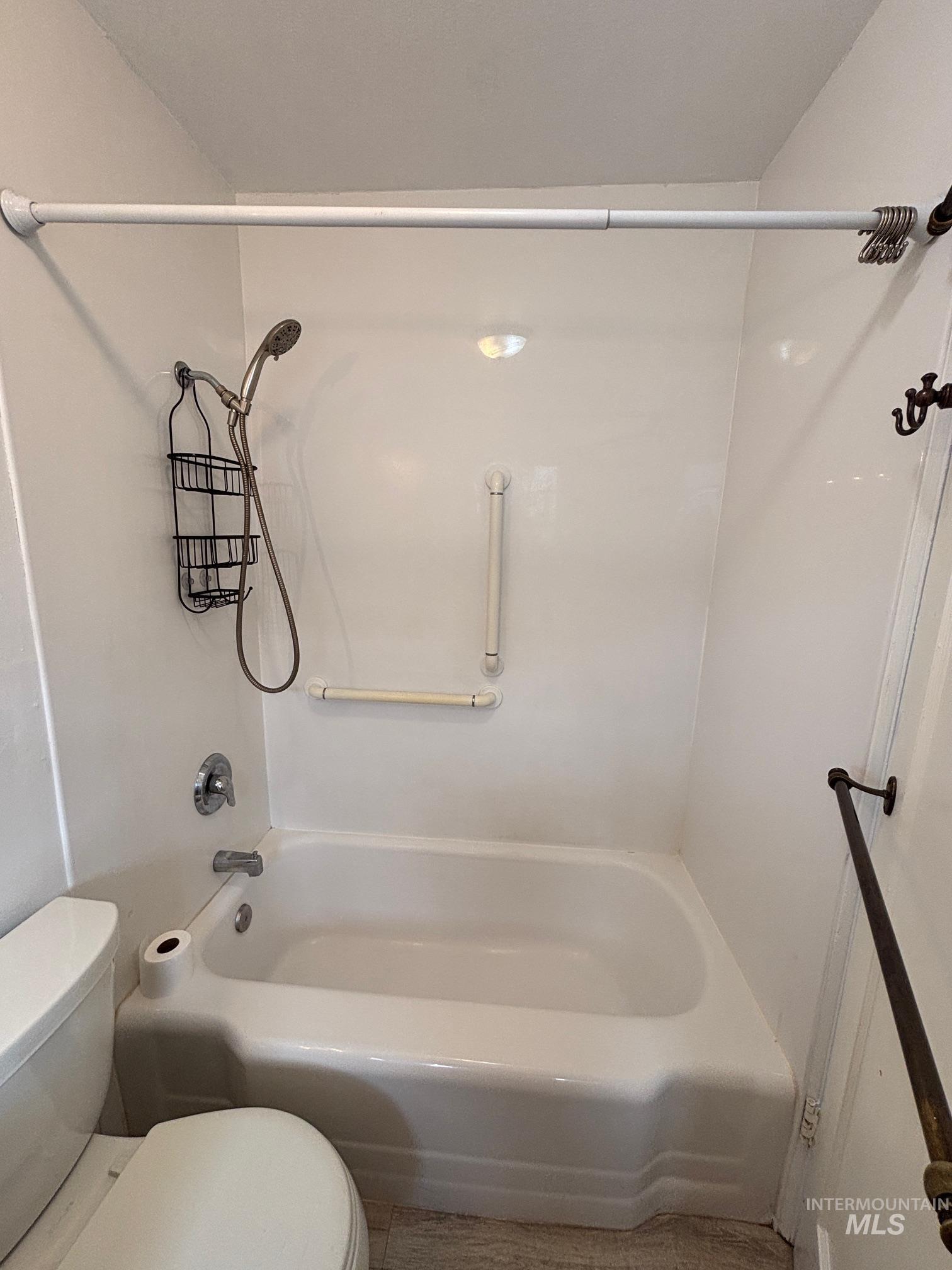 Full bathroom with toilet and shower / bathtub combination