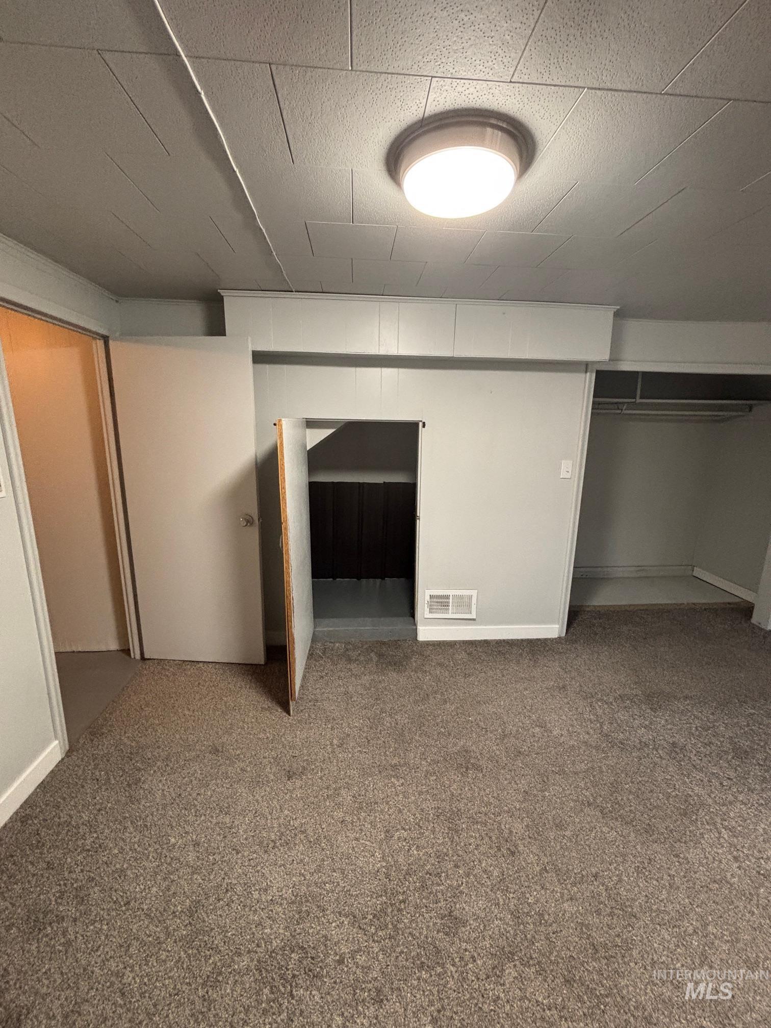 Unfurnished bedroom featuring carpet flooring