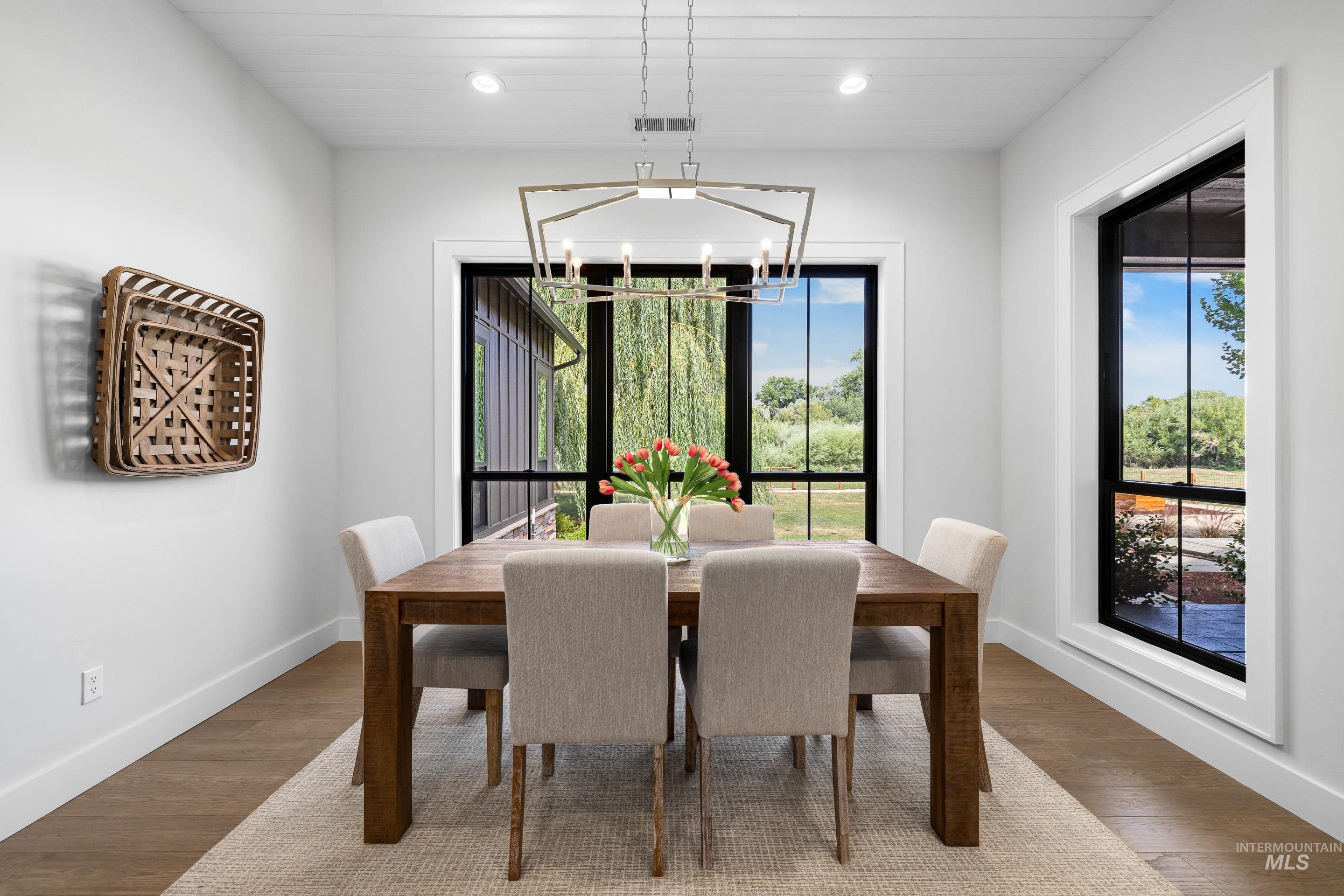 Dining room featuring wood finished floors, recessed lighting, and a chandelier