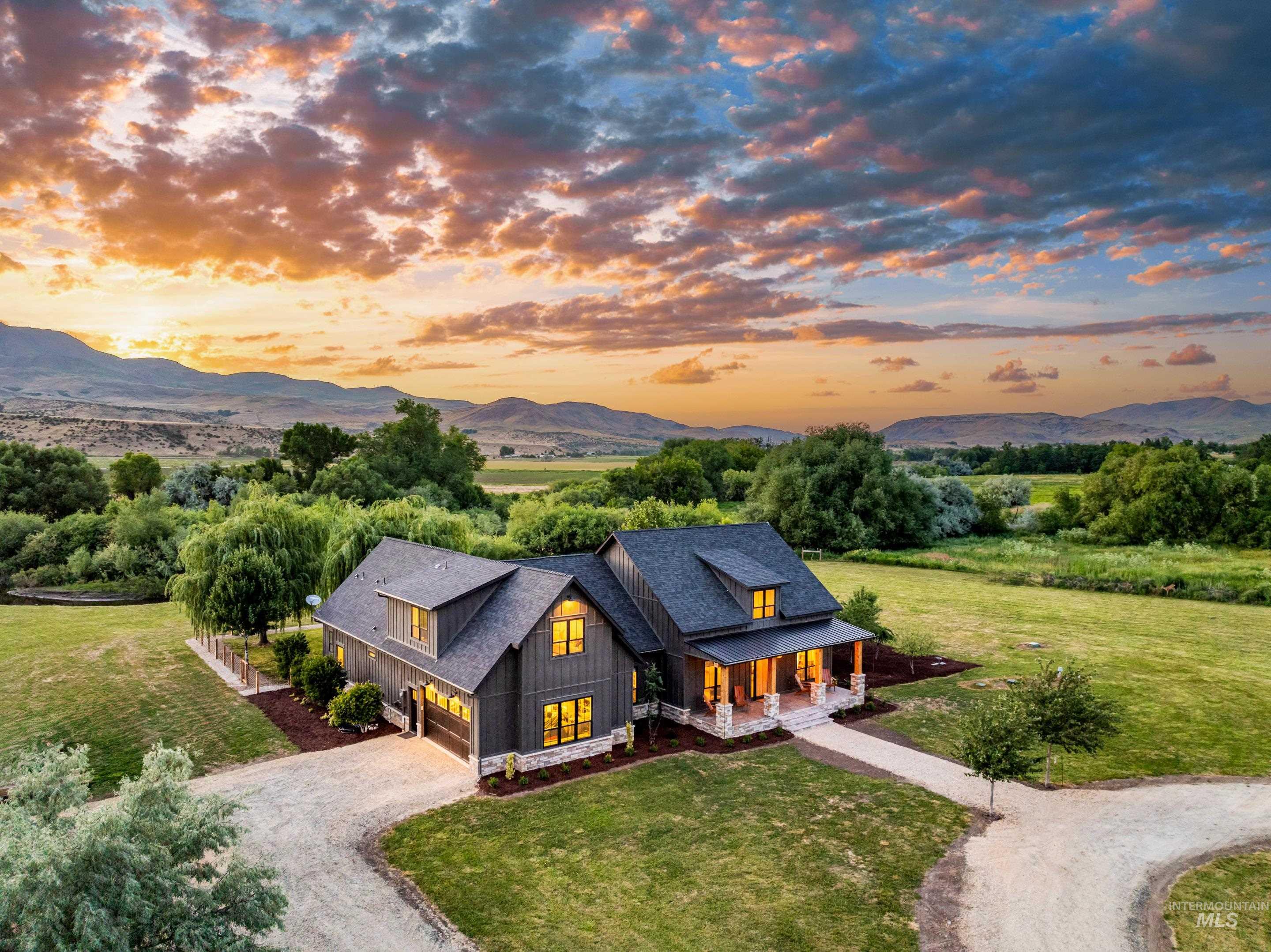 View of front of house with a porch, a mountain view, driveway, and a yard