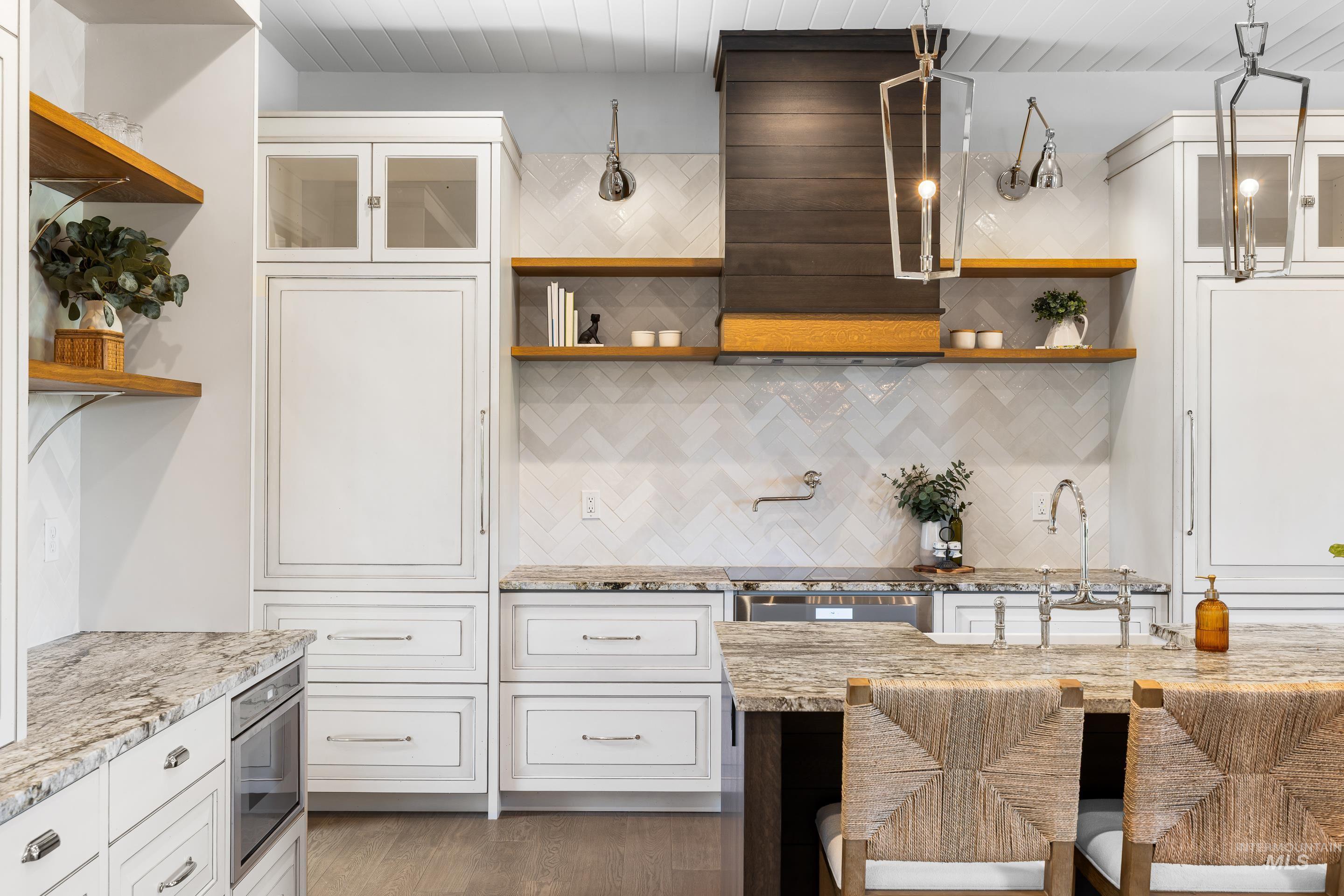 Kitchen featuring open shelves, glass insert cabinets, and backsplash