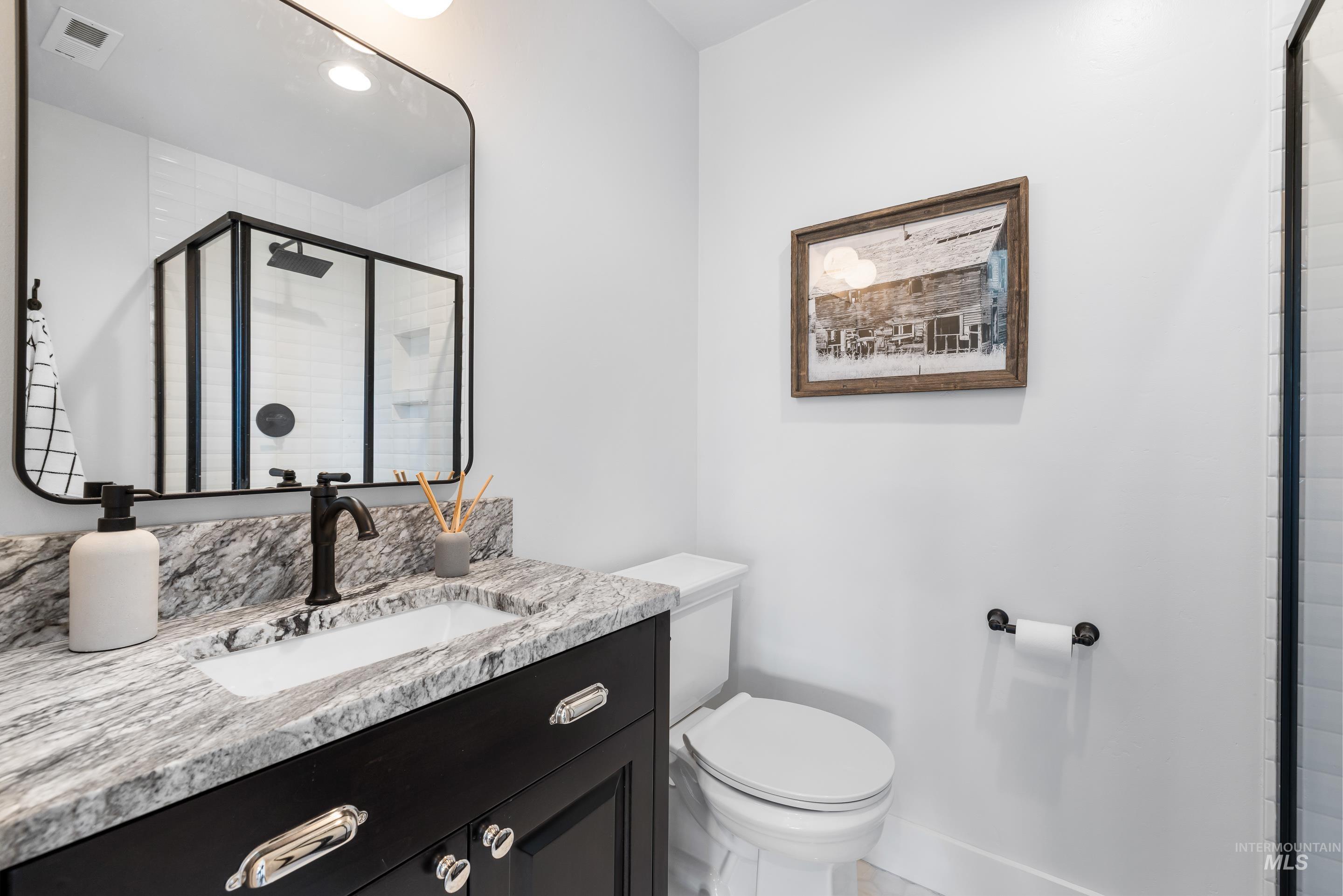 Bathroom featuring a stall shower and vanity