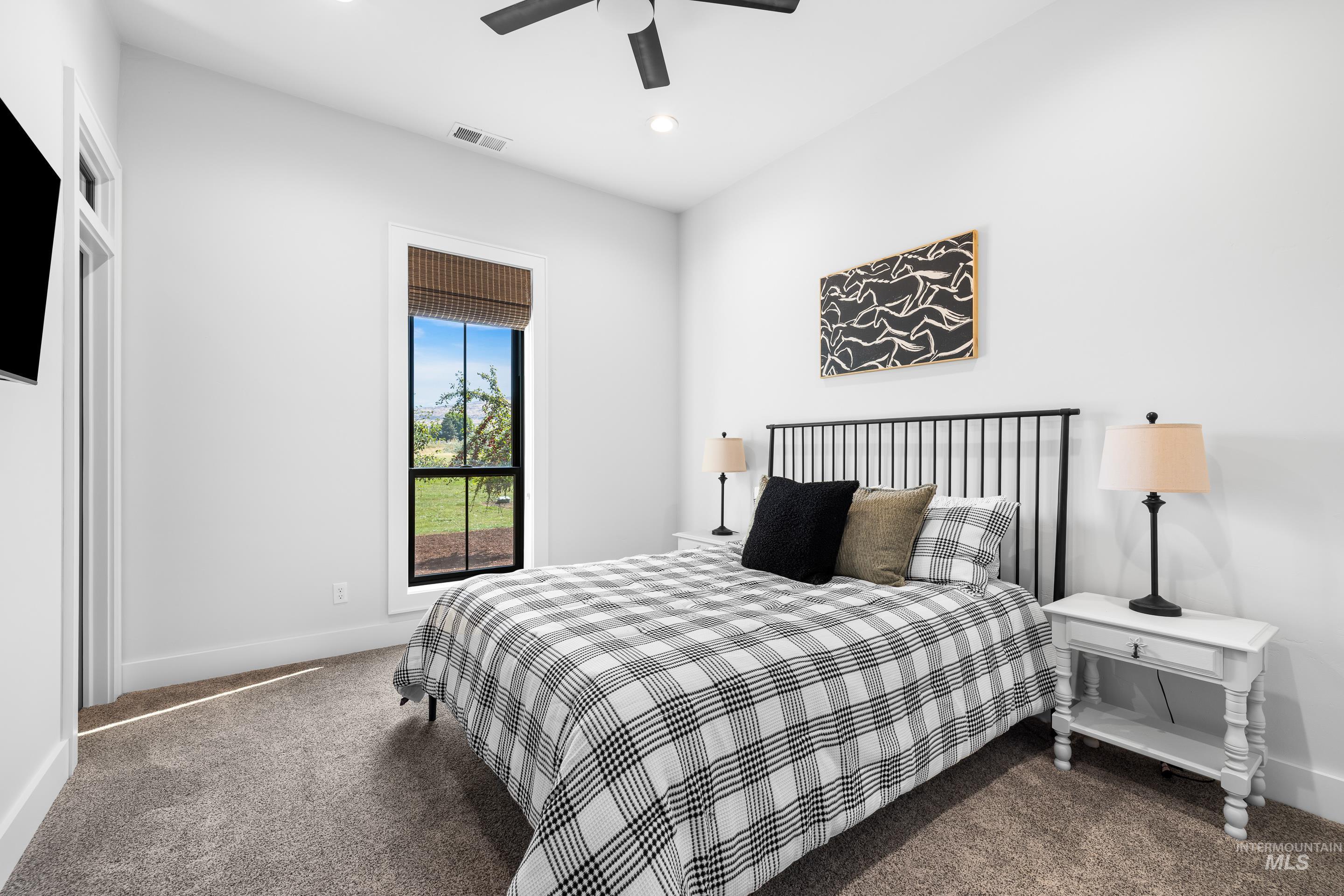 Bedroom featuring dark carpet, a ceiling fan, and recessed lighting