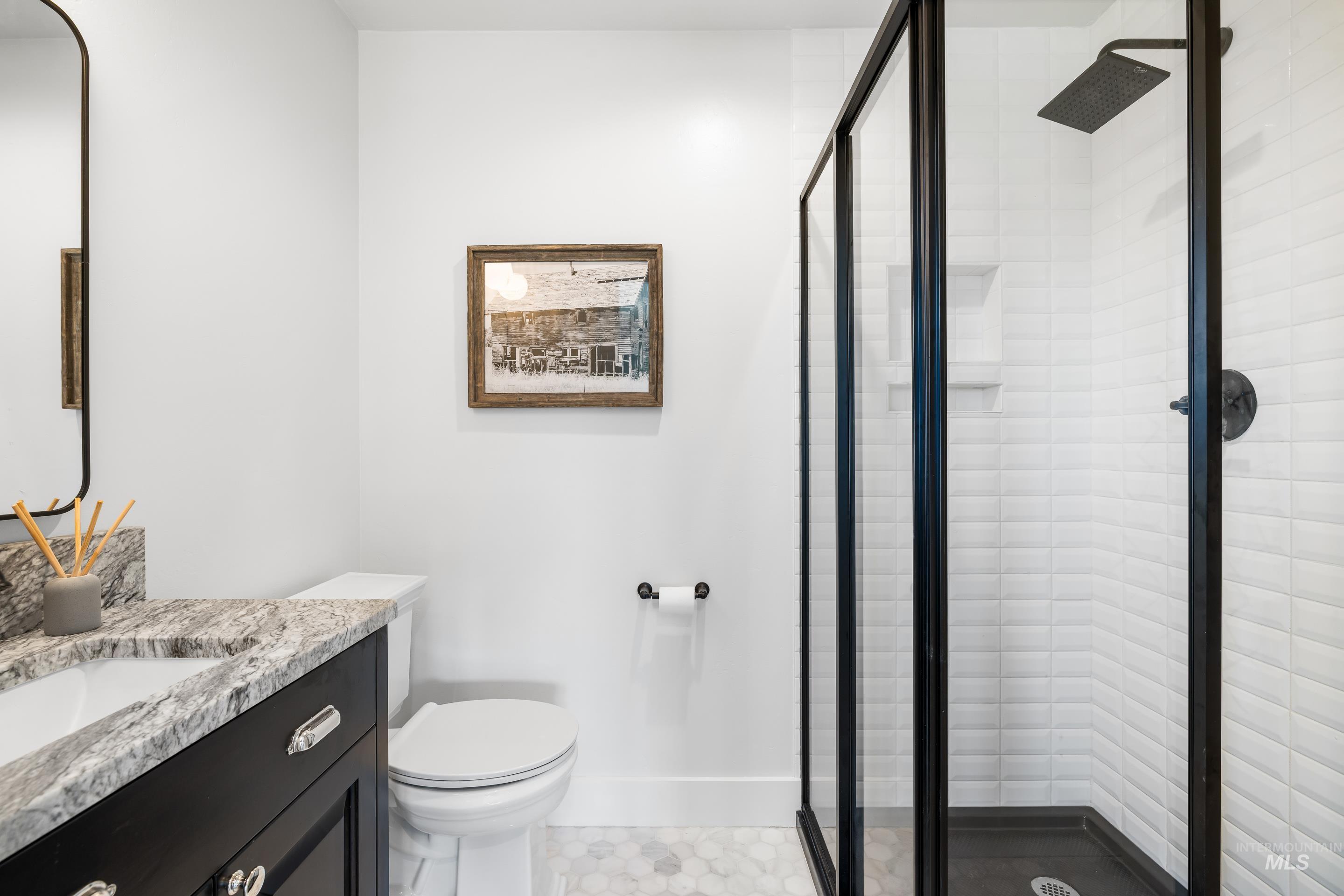 Full bath with vanity and a stall shower