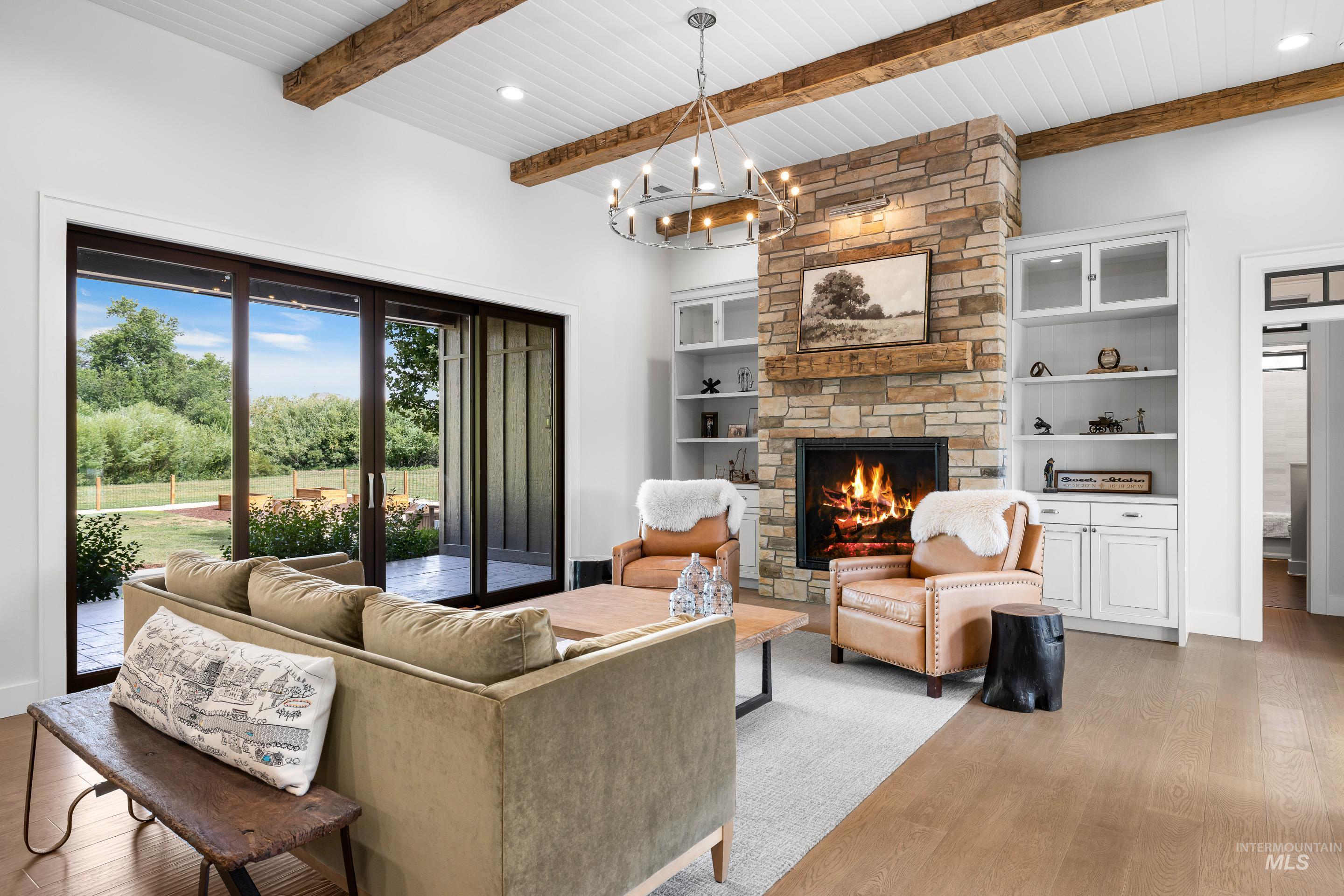 Living room featuring a fireplace, wood finished floors, a chandelier, a wood ceiling with exposed beams, and recessed lighting