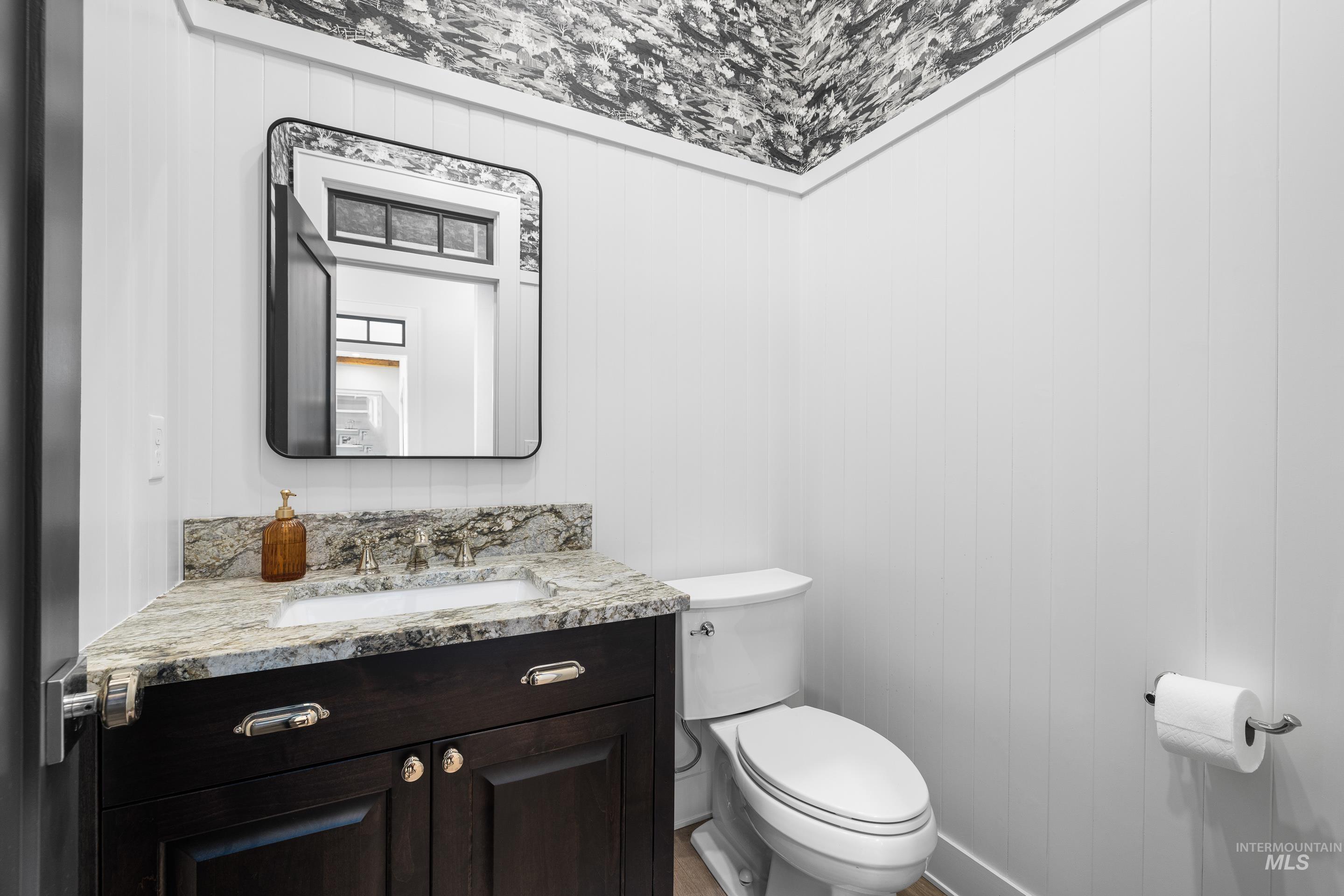 Bathroom featuring vanity and wood walls