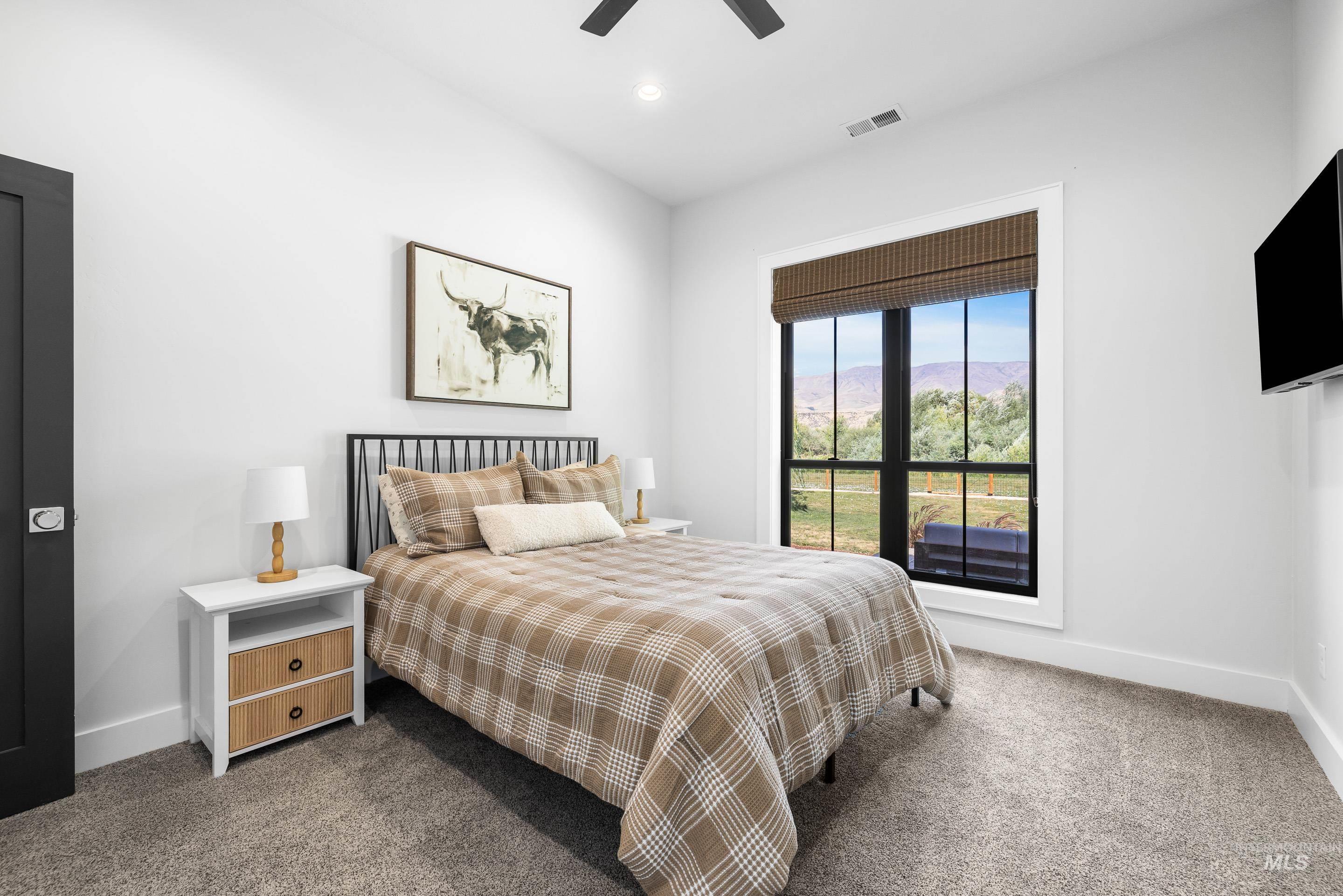 Carpeted bedroom featuring recessed lighting and ceiling fan