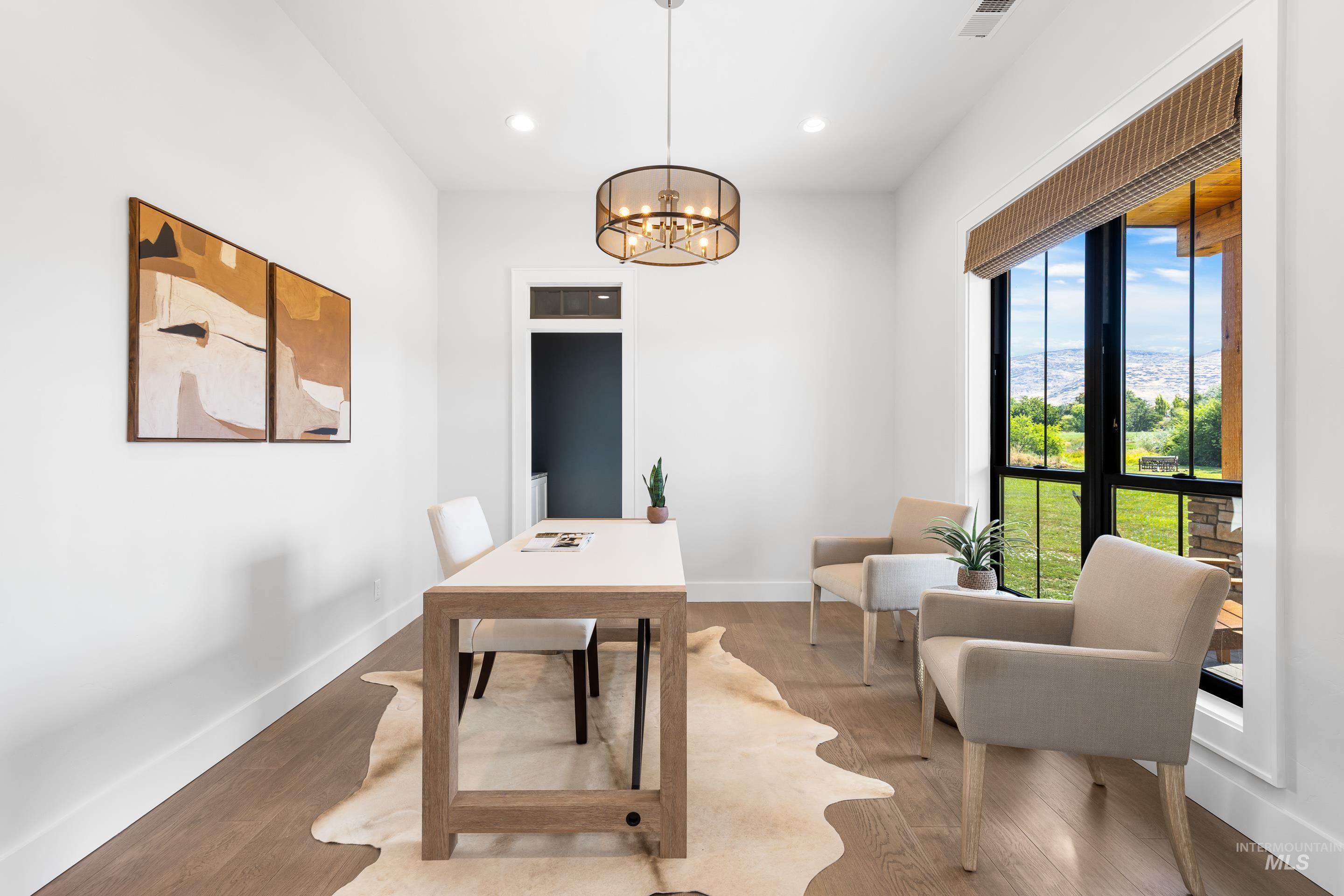 Office with a chandelier, recessed lighting, and wood finished floors