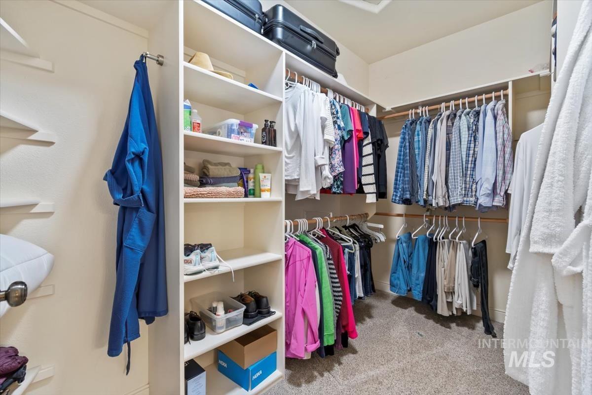 Large walk in closet with built in shelves.