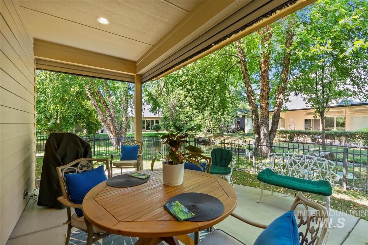 Covered back patio with electric privacy fencing. Sit and relax by the stream at the back of house.