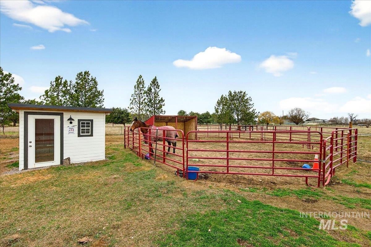 View of yard with an outbuilding and a rural view