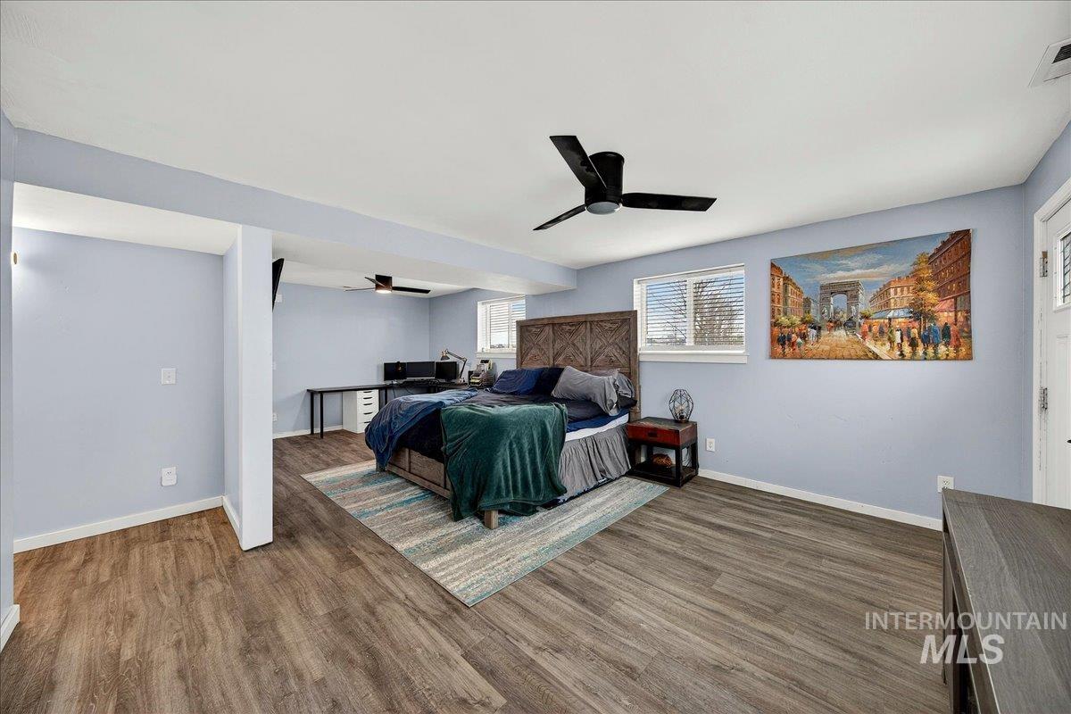 Bedroom featuring wood finished floors and a ceiling fan