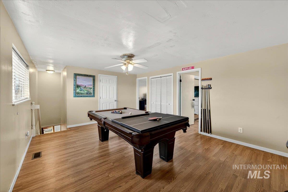 Rec room with billiards, a ceiling fan, and wood finished floors
