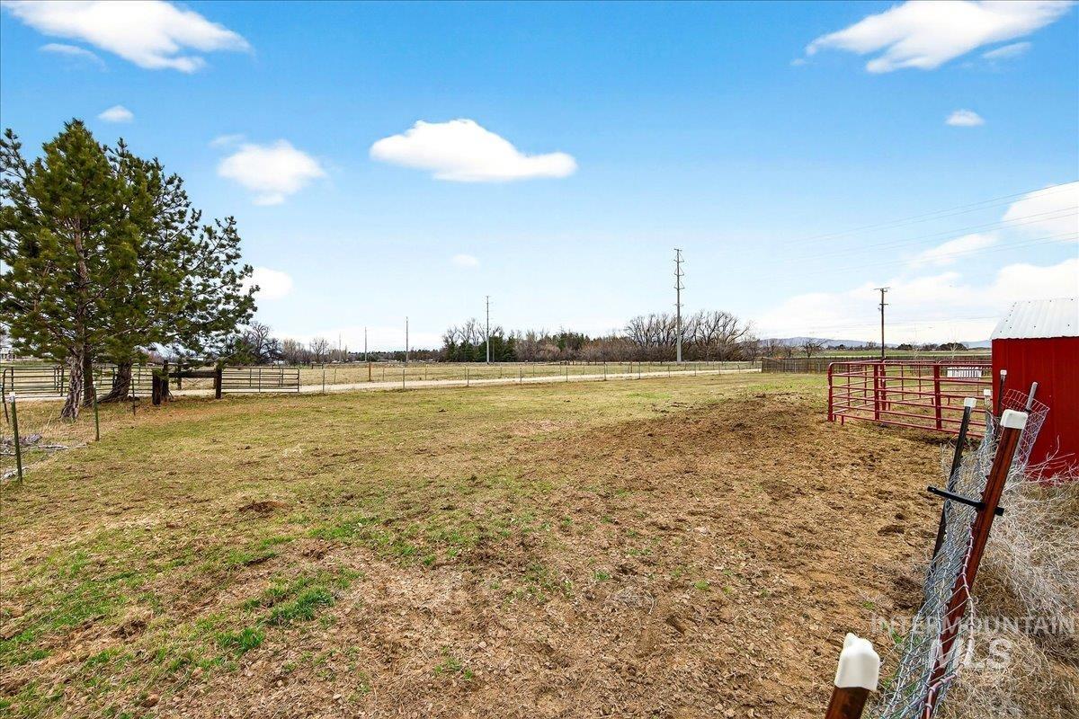 View of yard featuring a view of rural / pastoral area and an outdoor structure