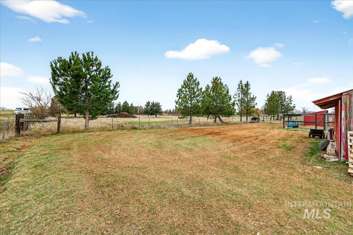 View of yard featuring a view of countryside and an outdoor structure