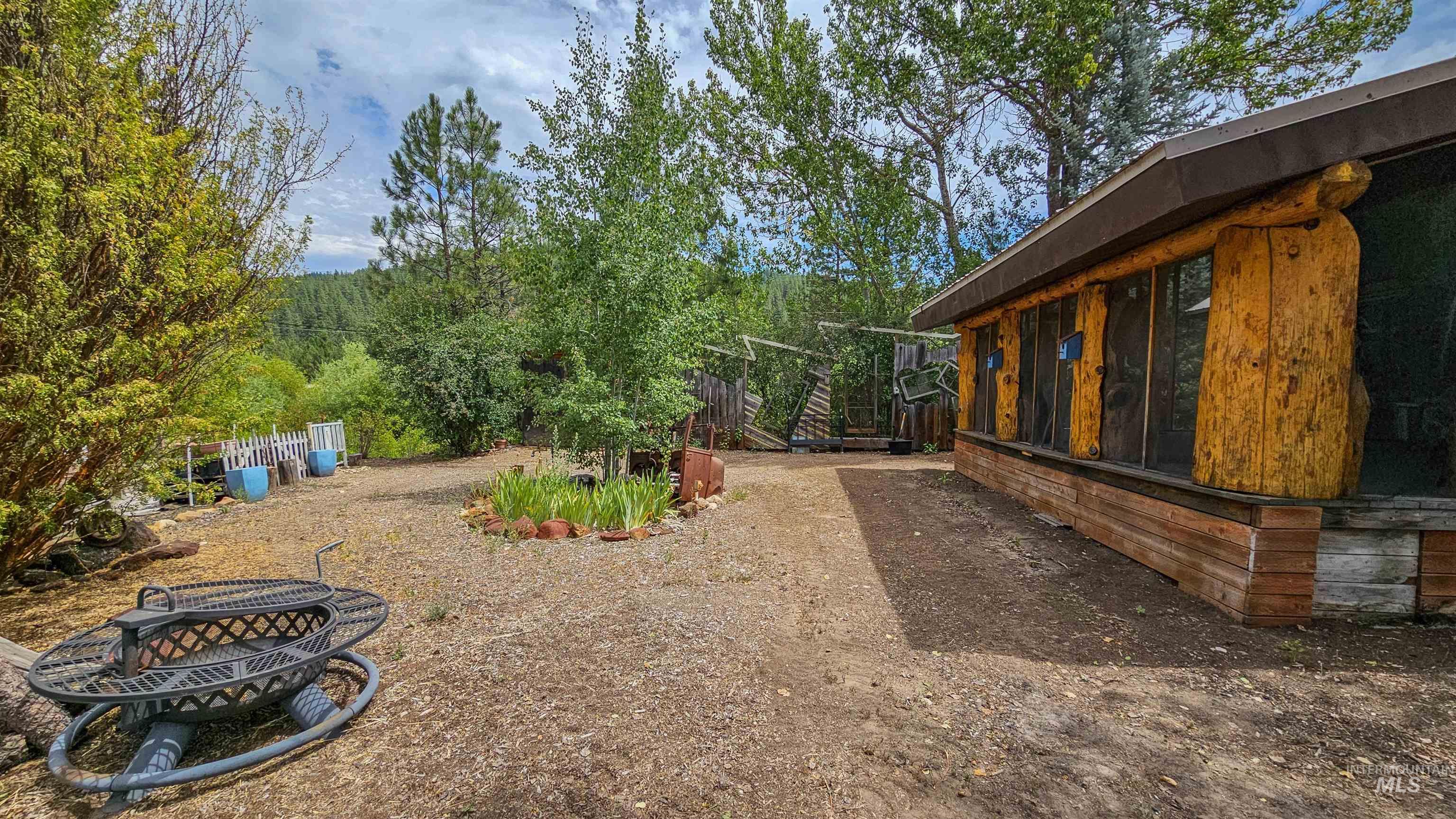 View of yard with an outdoor fire pit
