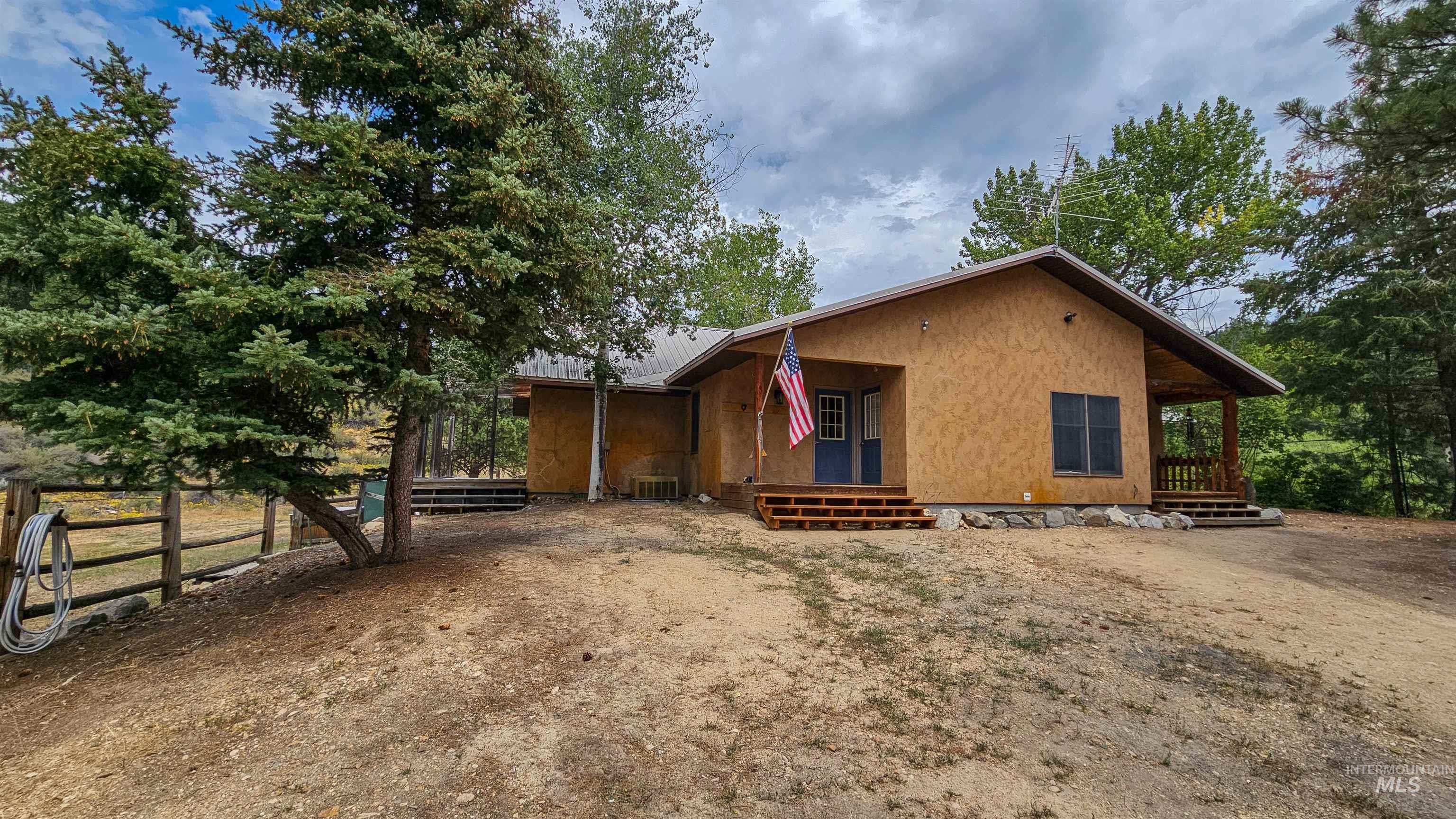 View of front of property featuring a metal roof and stucco siding