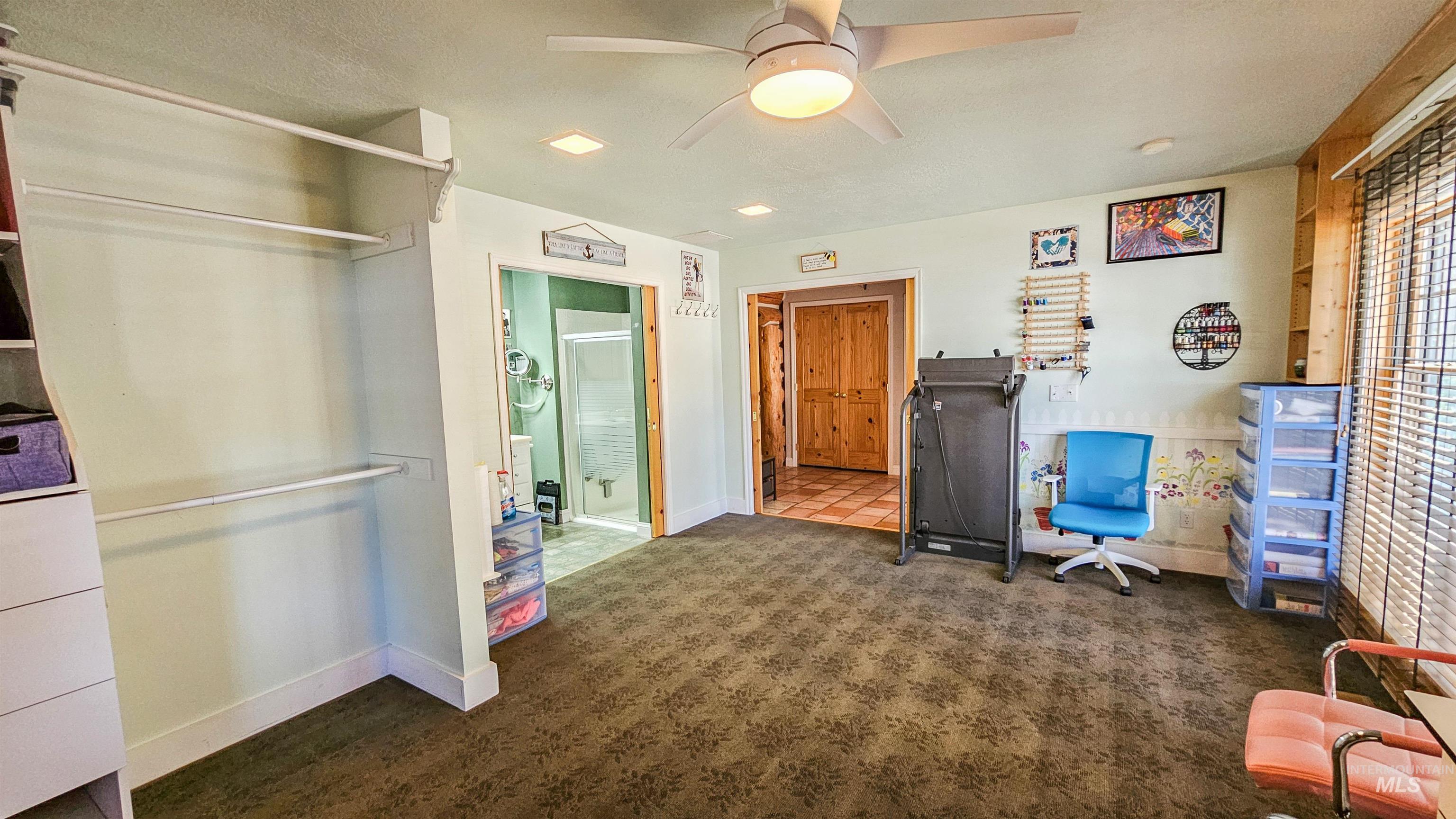 Back of house with a sunroom, a metal roof, and entry steps