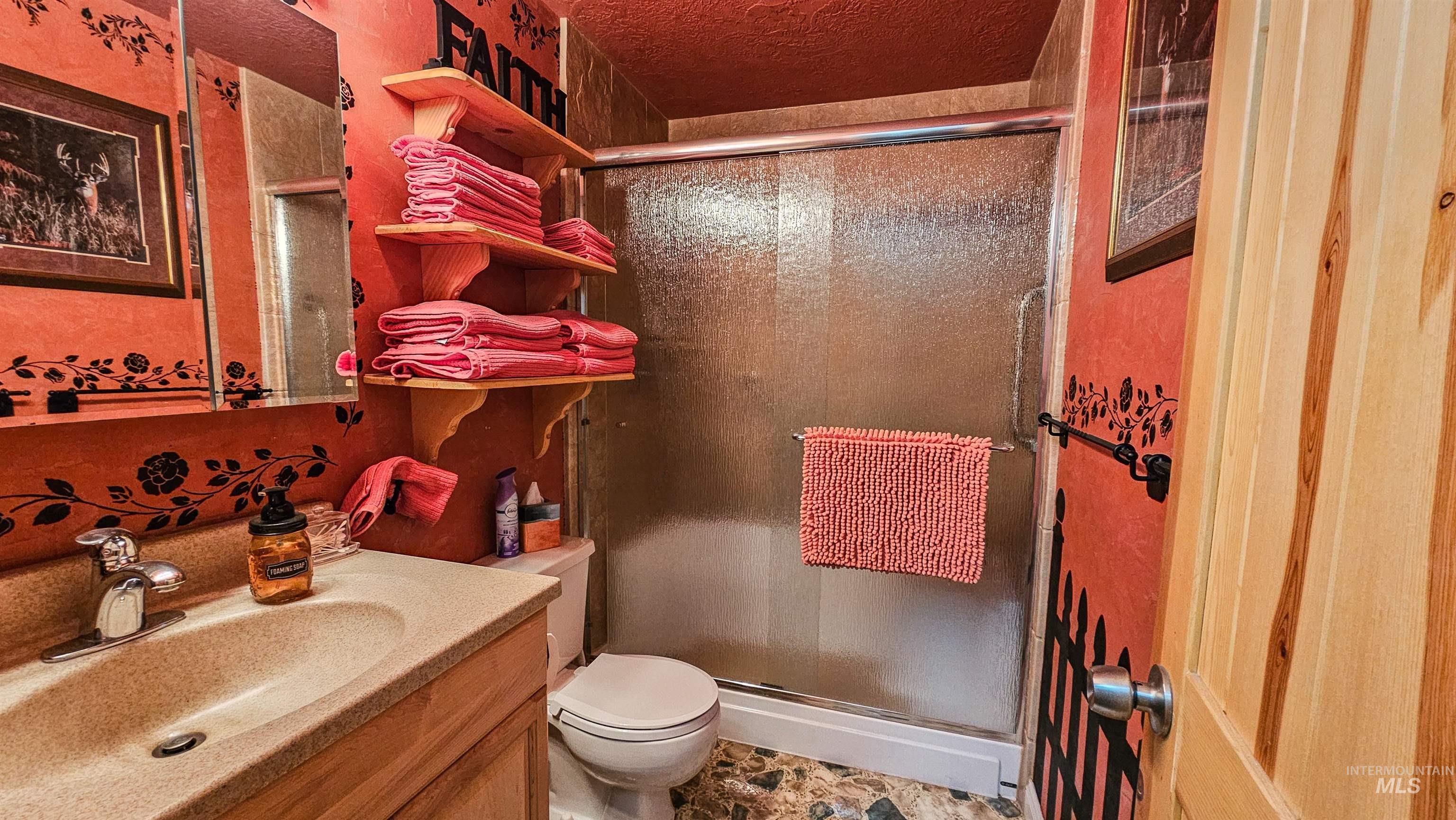 Bathroom with vanity and a stall shower