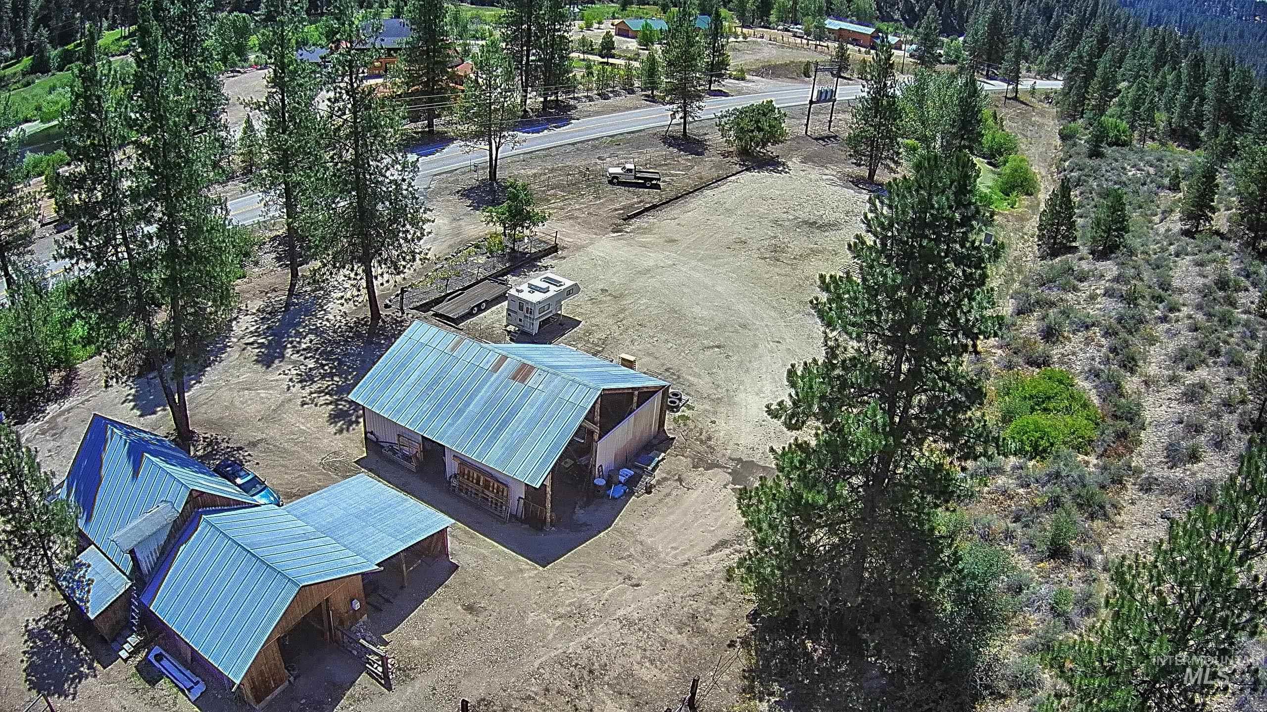 View of asphalt street featuring a view of trees