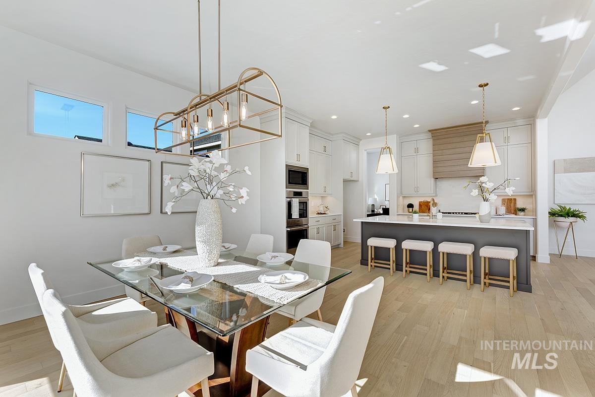 Dining space featuring light wood-style floors, a chandelier, and recessed lighting