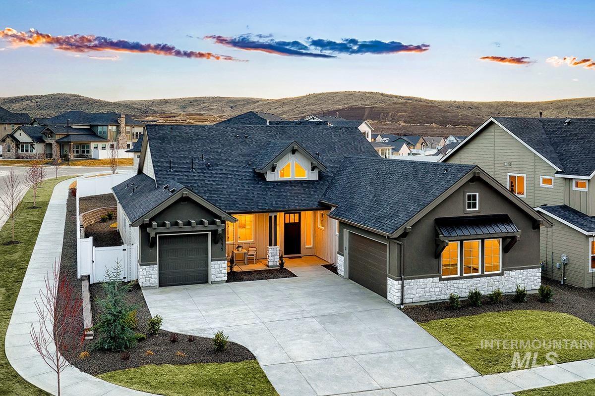 View of front of property with stone siding, stucco siding, concrete driveway, a porch, and an attached garage