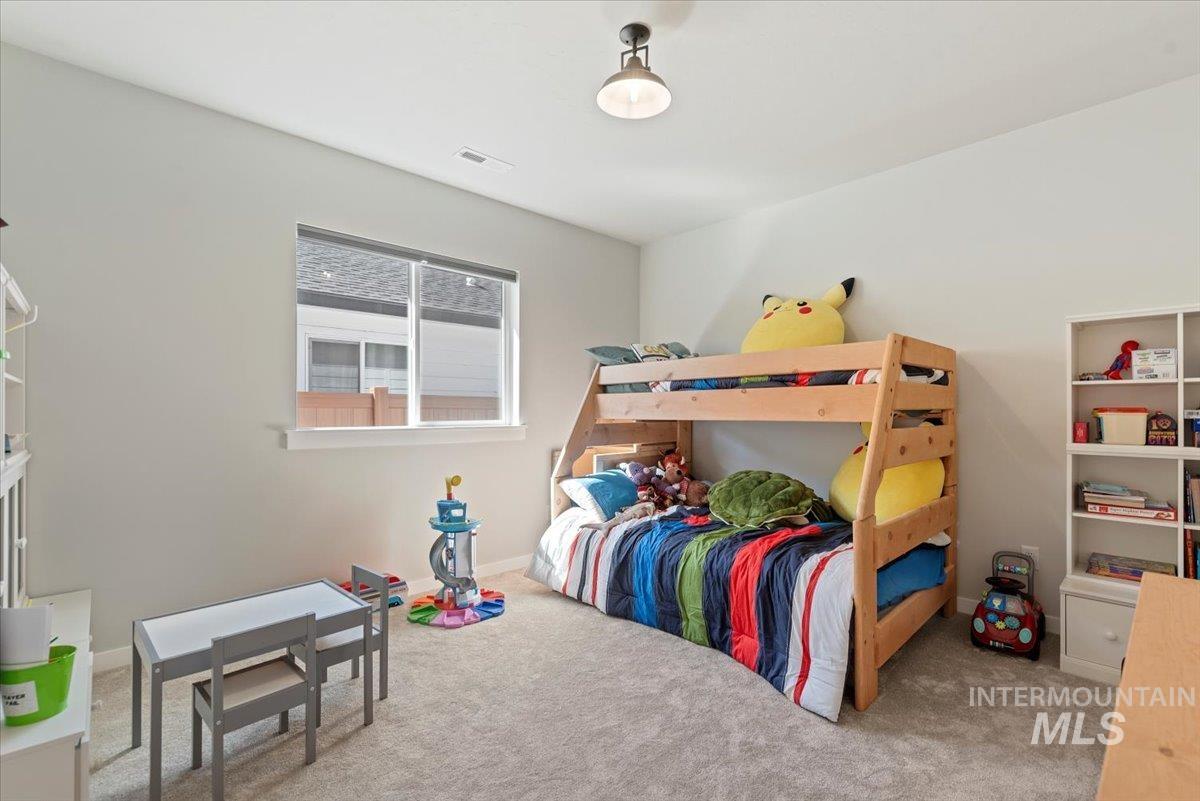 Carpeted bedroom featuring baseboards