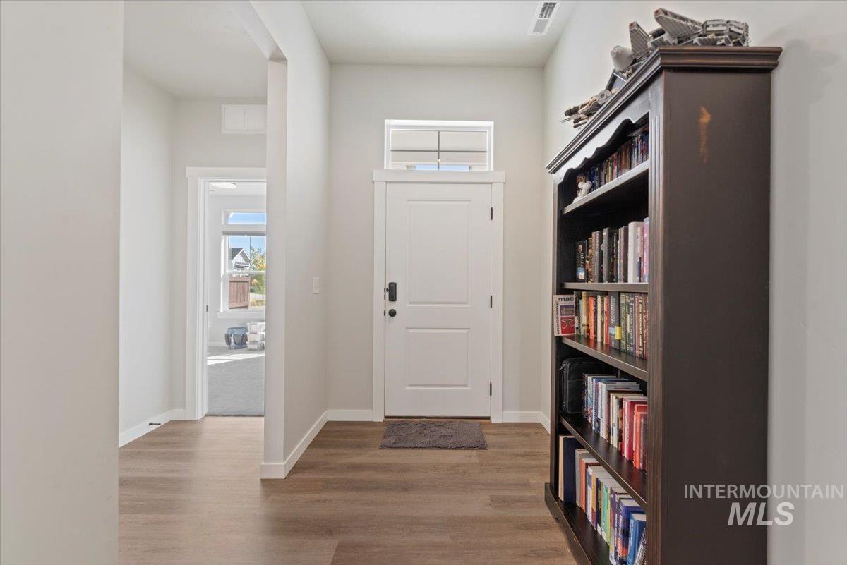 Foyer entrance featuring baseboards and dark wood-style floors