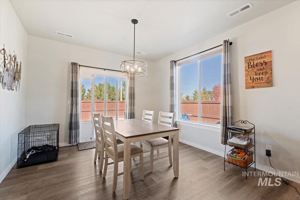 Dining space featuring wood finished floors and a chandelier