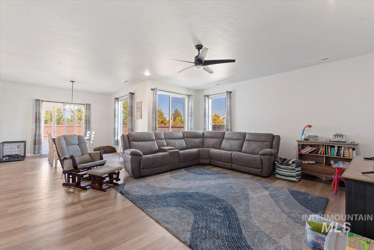 Living room featuring wood finished floors, ceiling fan, and a textured ceiling