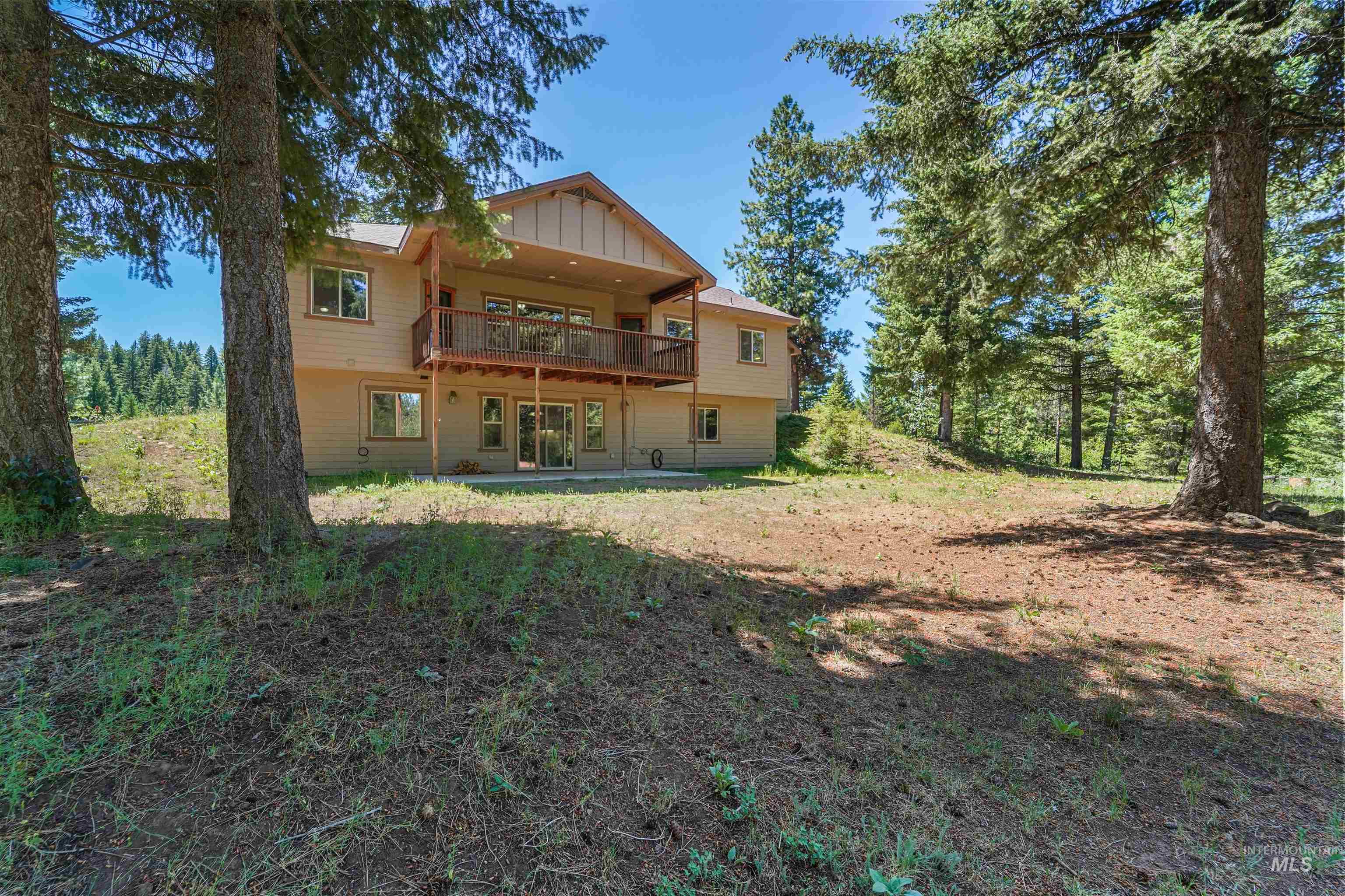 Rear view of property featuring board and batten siding and a deck