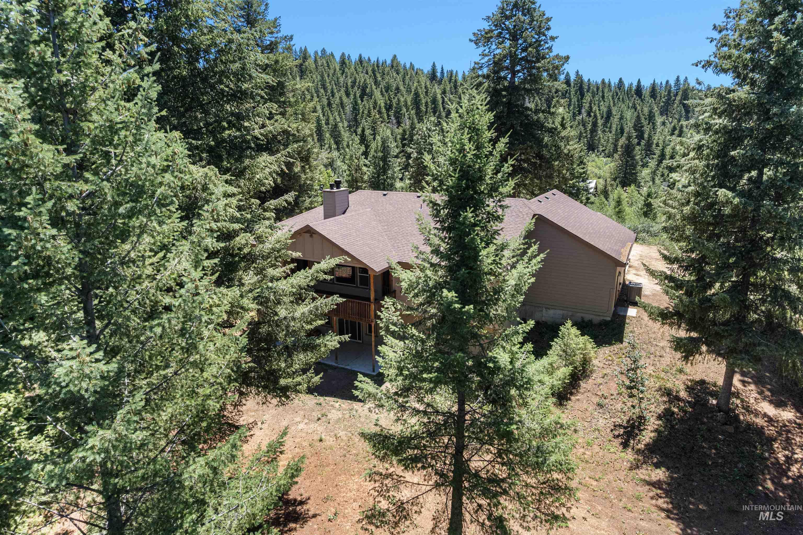 View from above of property with a forest