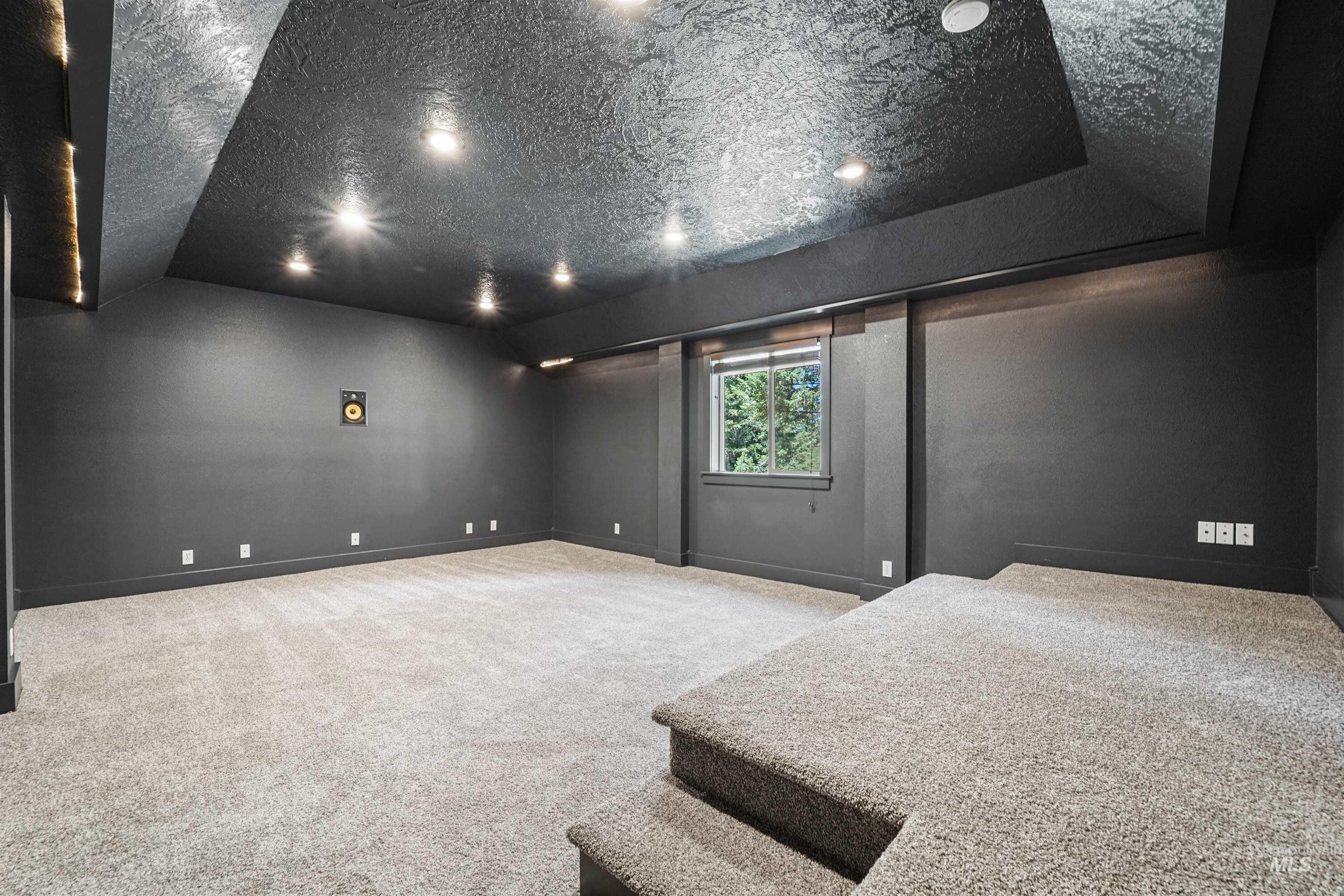 Bedroom featuring carpet and baseboards