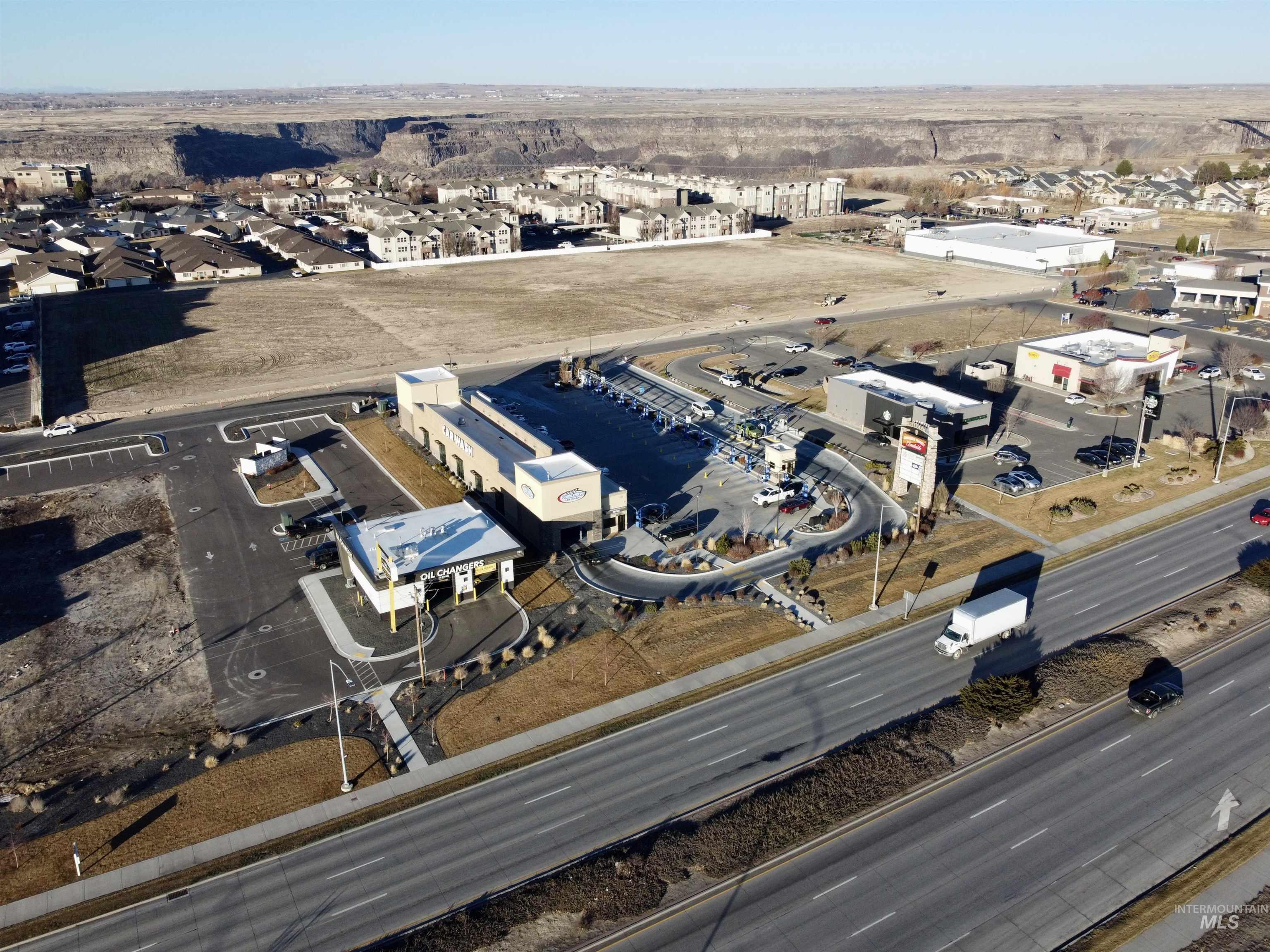 Aerial view of property and surrounding area with an industrial area