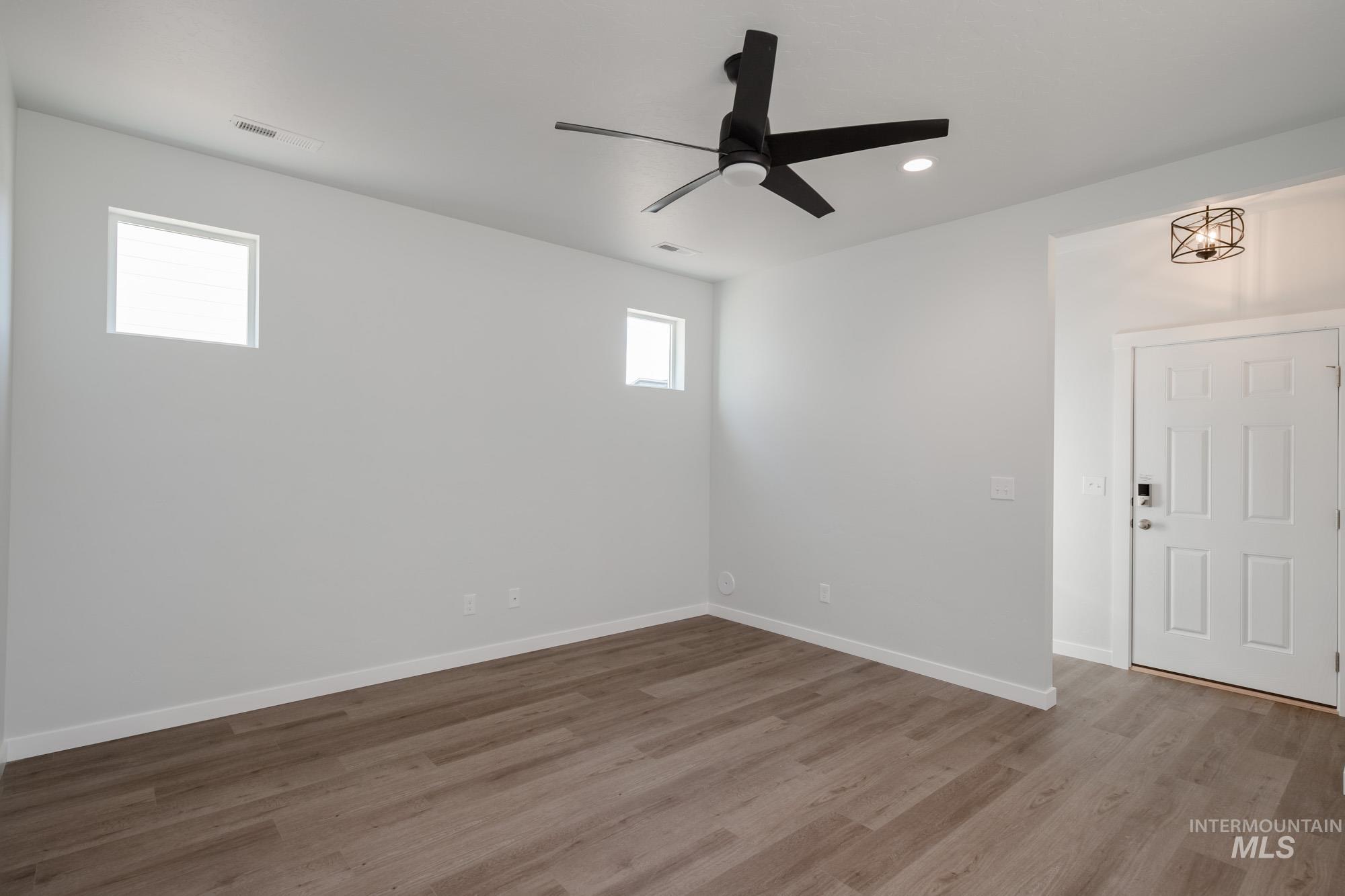 Empty room with light wood-style flooring, a ceiling fan, and recessed lighting