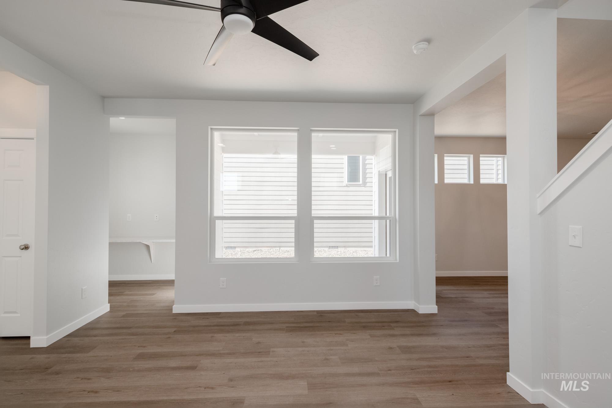 Unfurnished room featuring wood finished floors and a ceiling fan