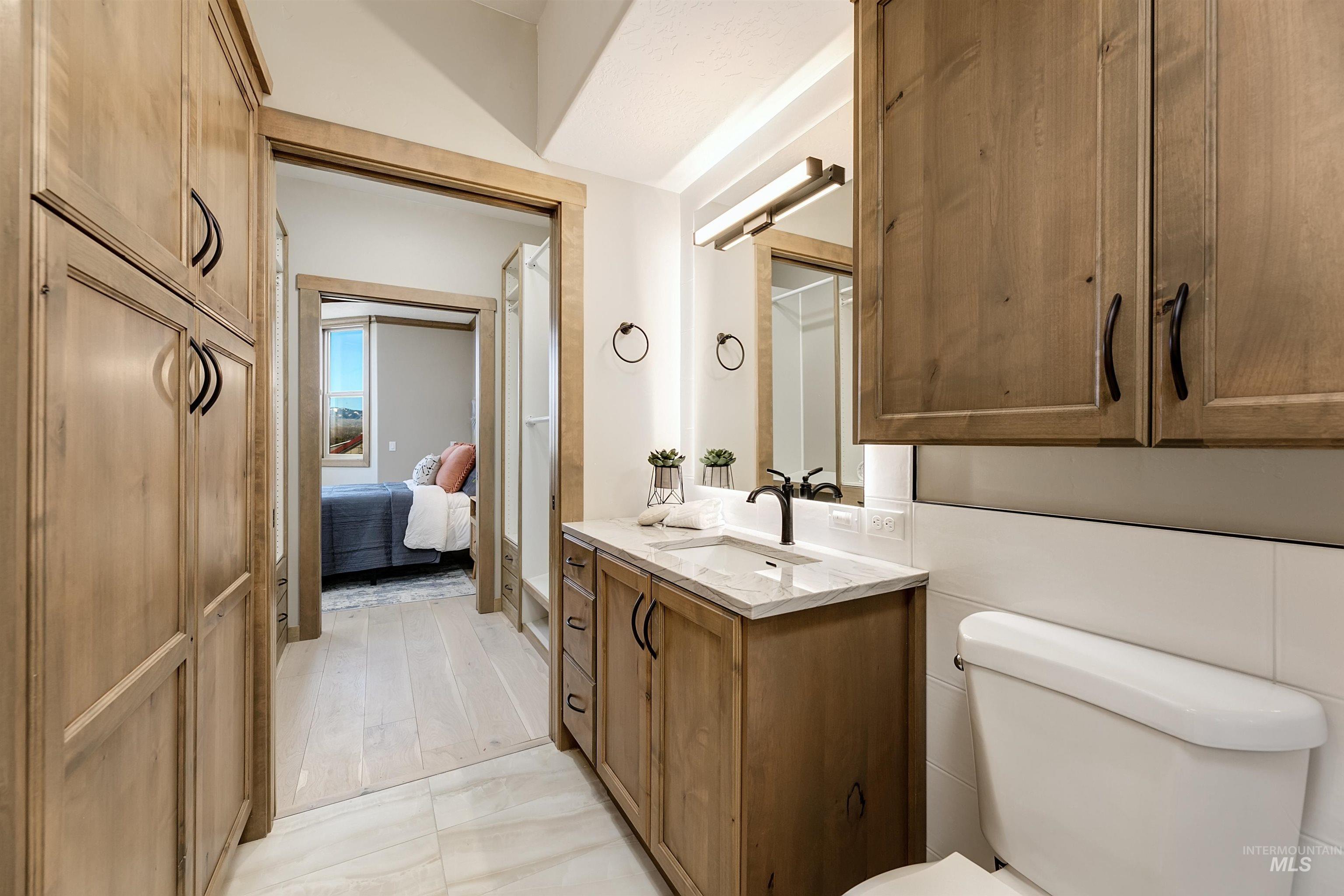 Full bathroom with vanity and ensuite bathroom