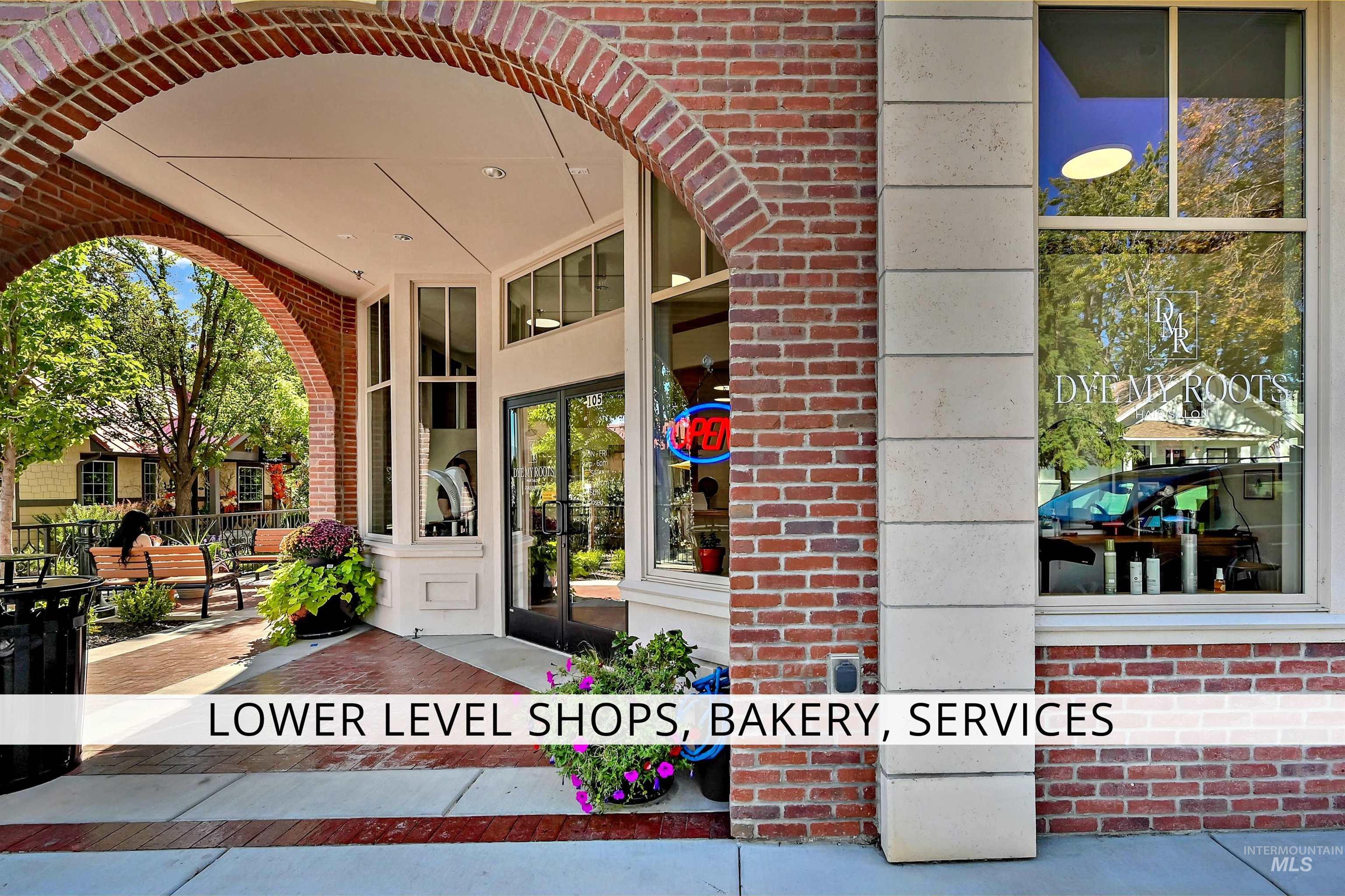 View of exterior entry featuring brick siding and a patio
