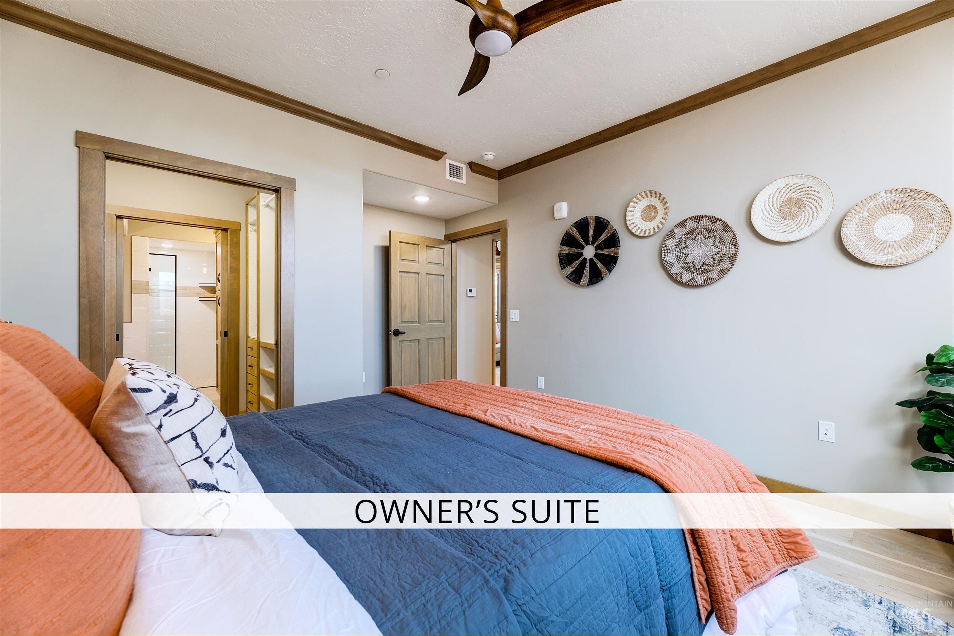 Bedroom with crown molding, ensuite bathroom, and a ceiling fan