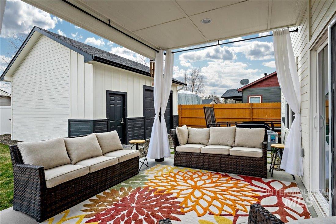 View of patio / terrace featuring an outdoor living space and an outbuilding