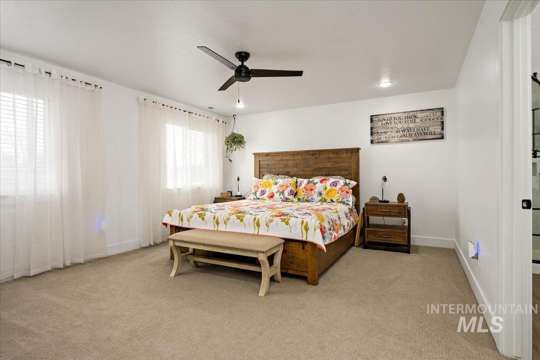 Bedroom featuring light carpet, a ceiling fan, and recessed lighting