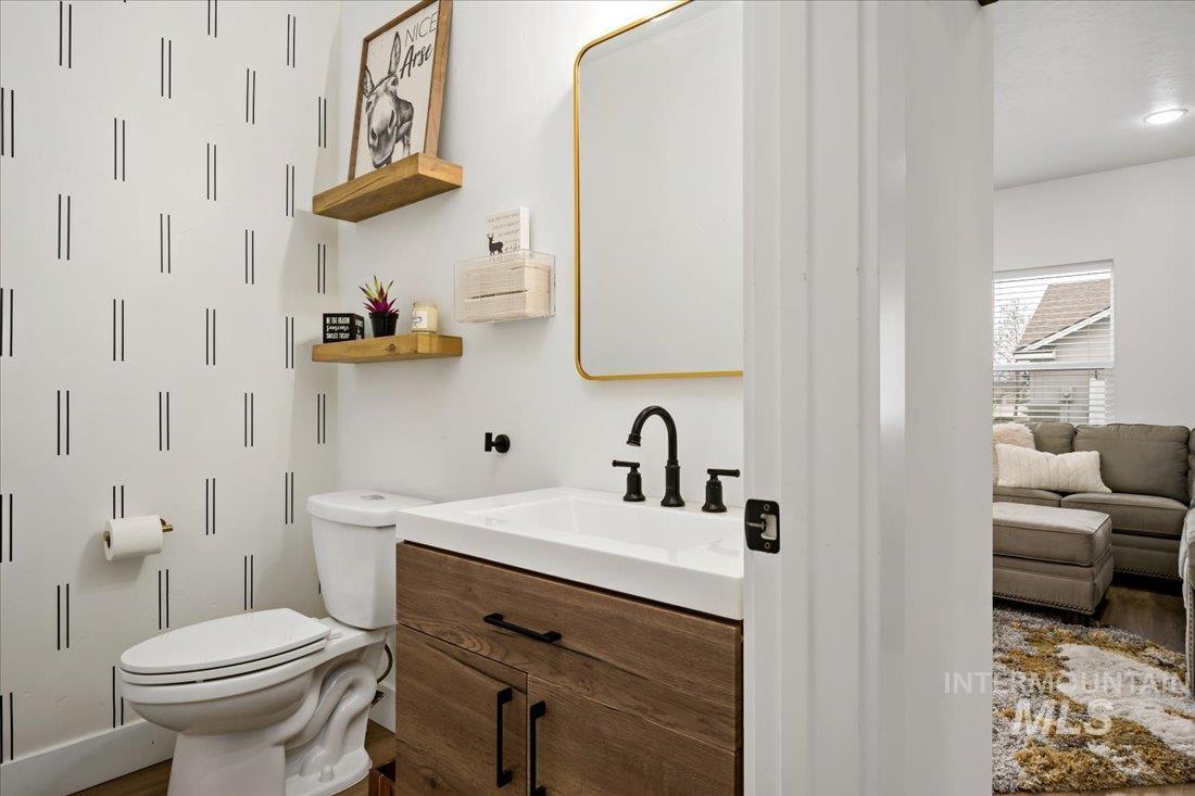 Bathroom featuring vanity and dark wood-style flooring