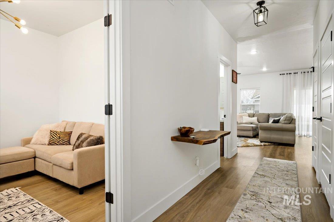Hallway with dark wood finished floors and baseboards