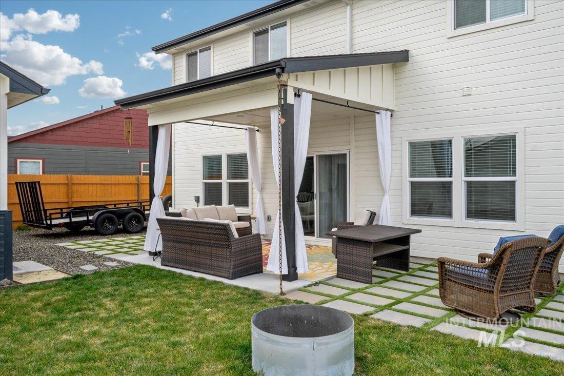 Back of house with an outdoor hangout area and a patio area