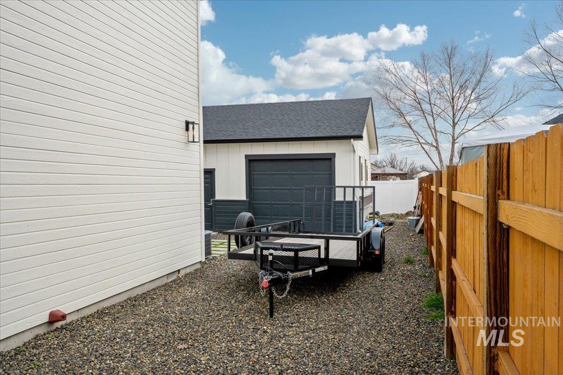 View of side of property featuring a shingled roof