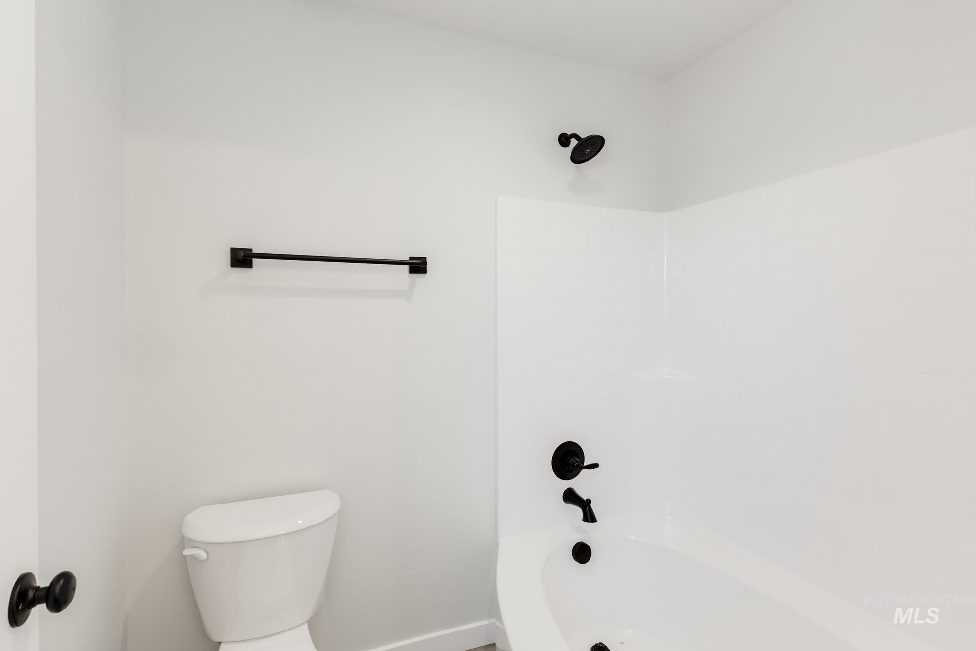 Full bathroom with shower / bath combination and toilet